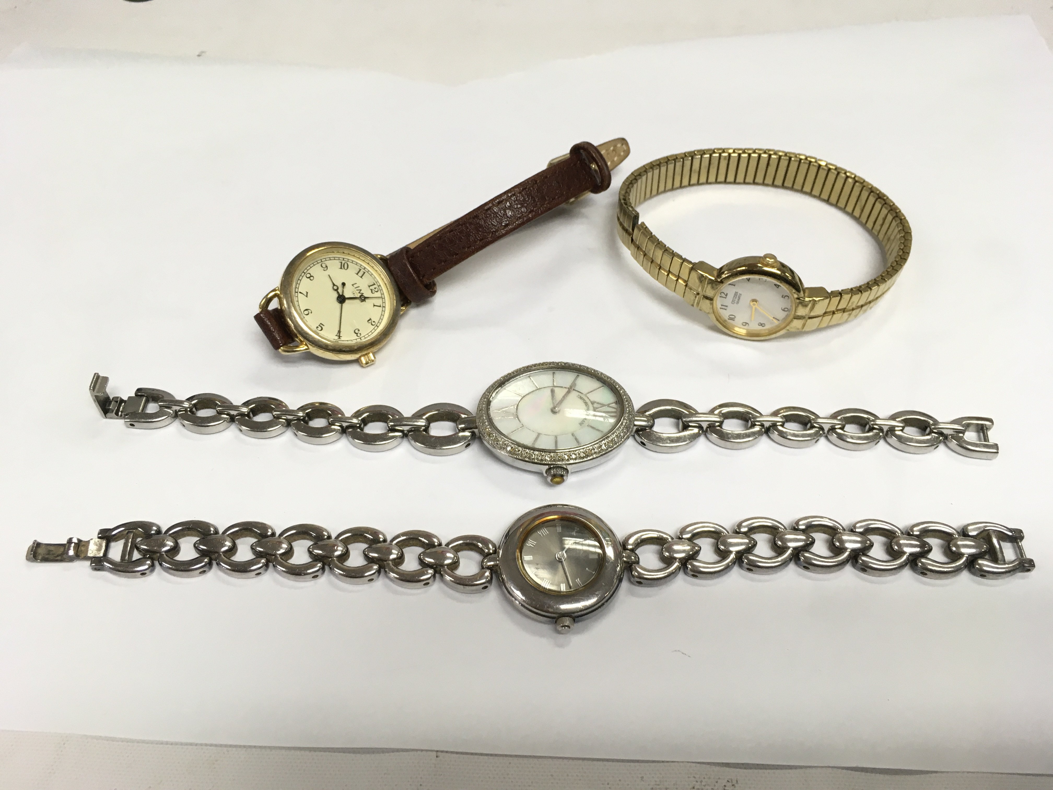 A silver ladies watch and three others. Shipping category A.