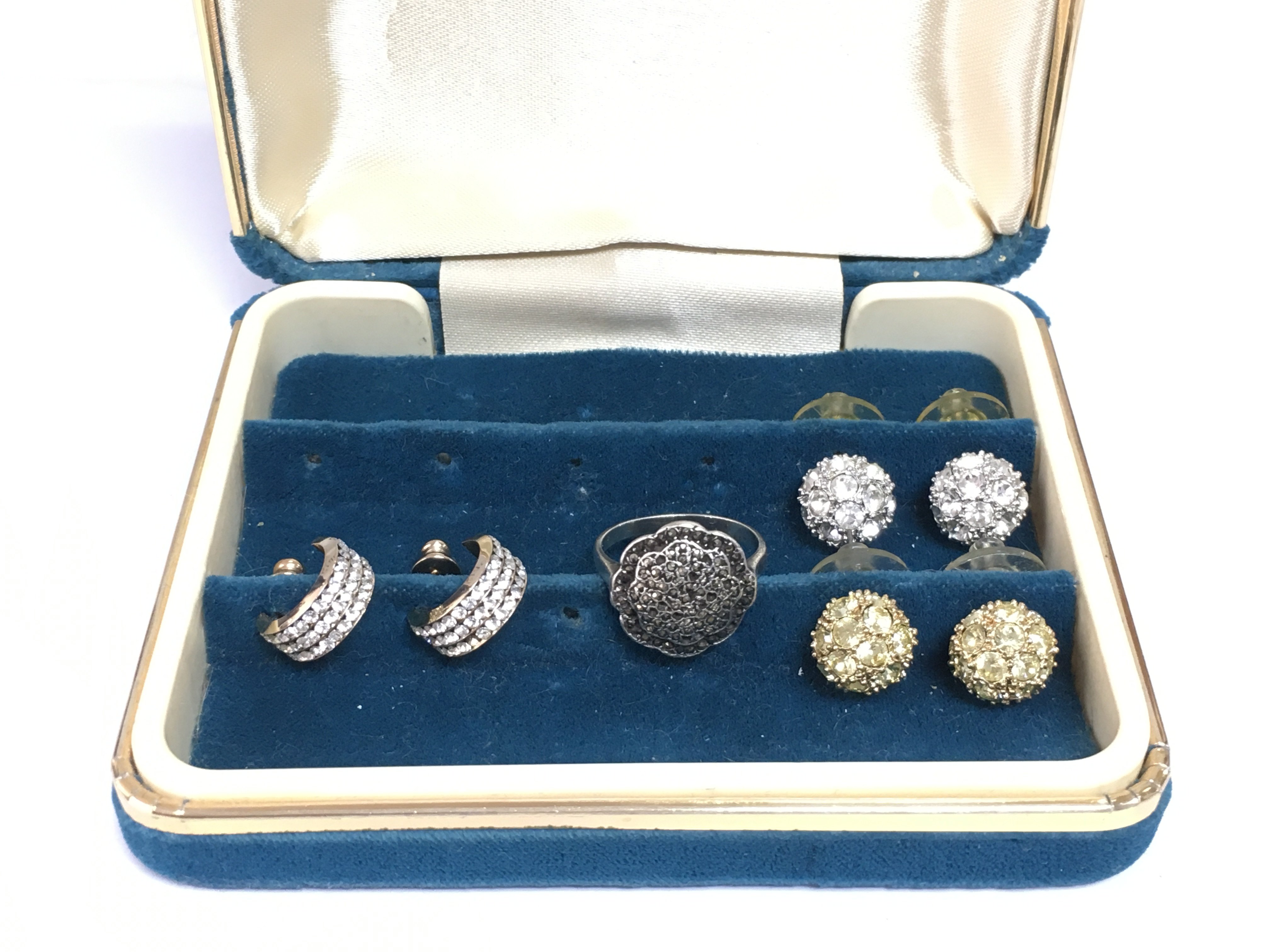 A silver marcasite ring and three pairs of earrings set with CZ stones. Shipping category A.