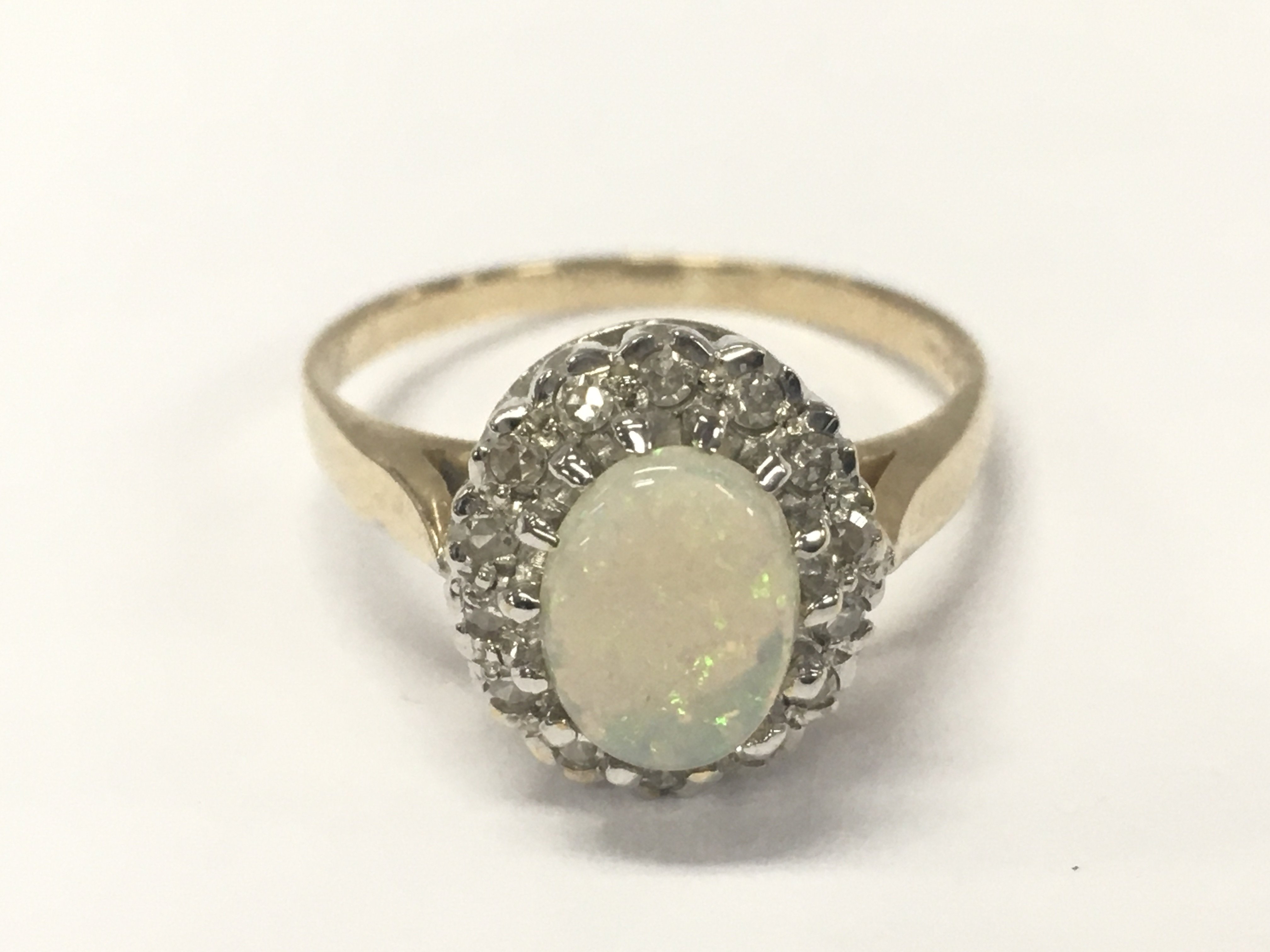 A 9 carat gold opal ring , 3.2g total weight, size O. postage category A