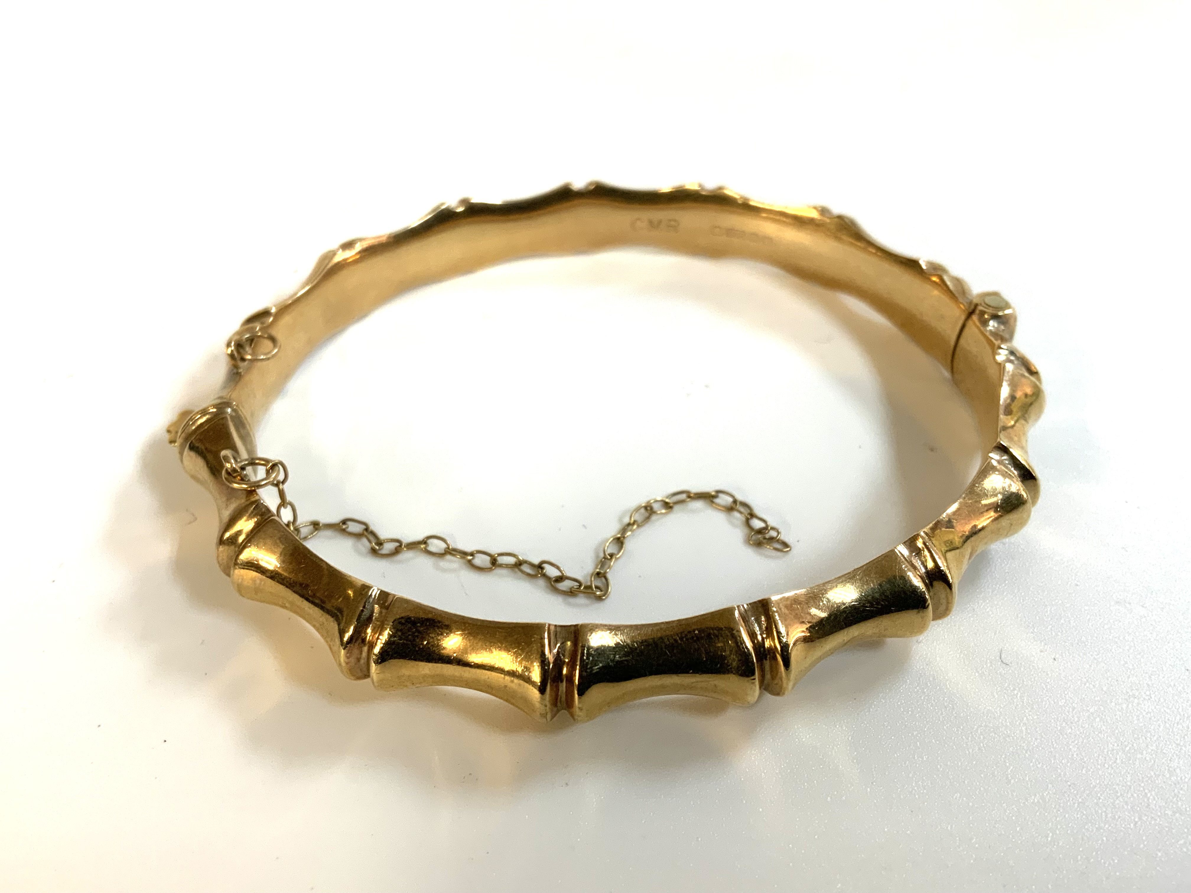 A 9ct gold bamboo design bangle, (A)