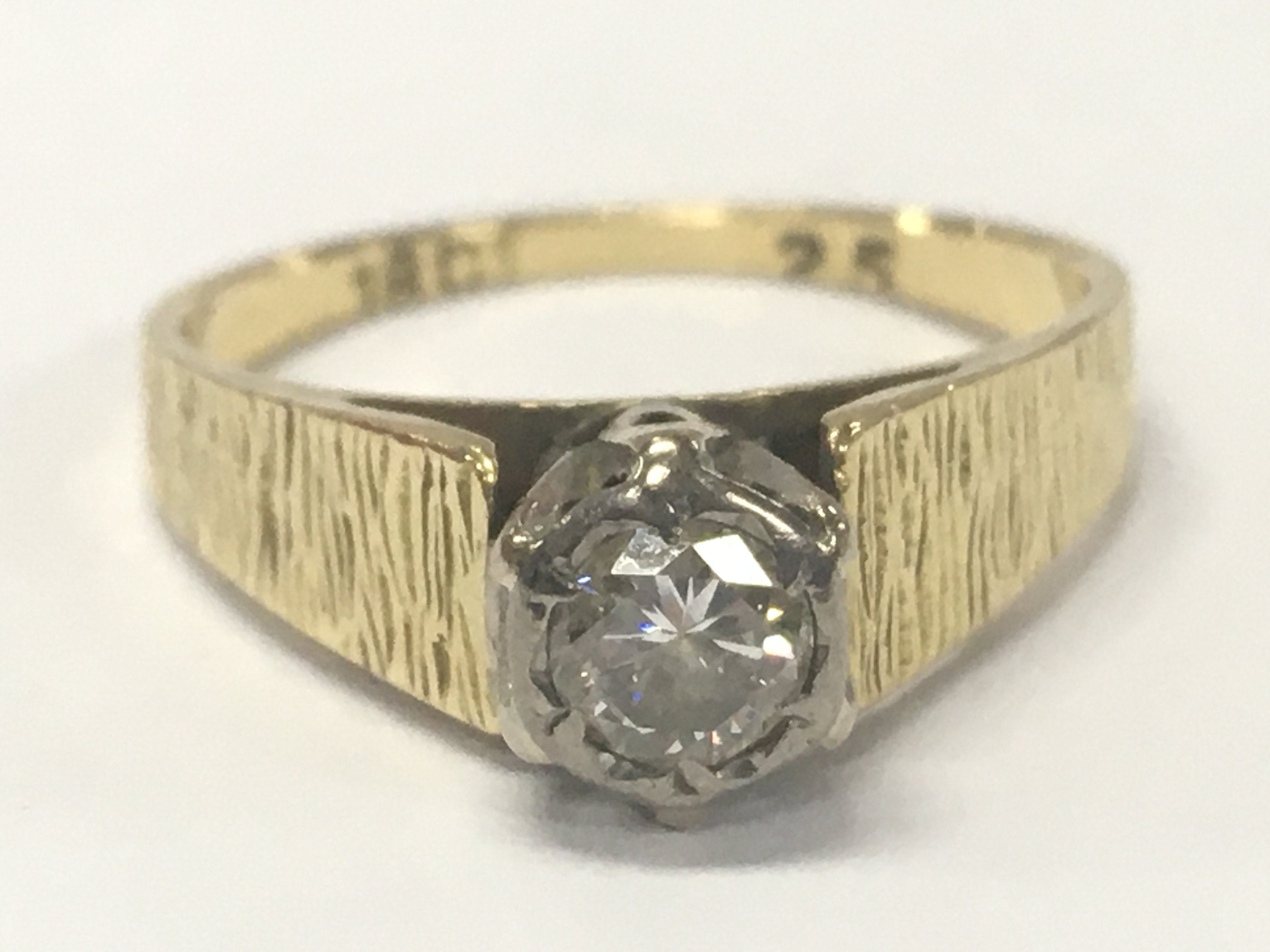 An 18ct gold ring set with a diamond stone , Approx 0.25ct. 3.5g total weight. Size M/N. Postage category A