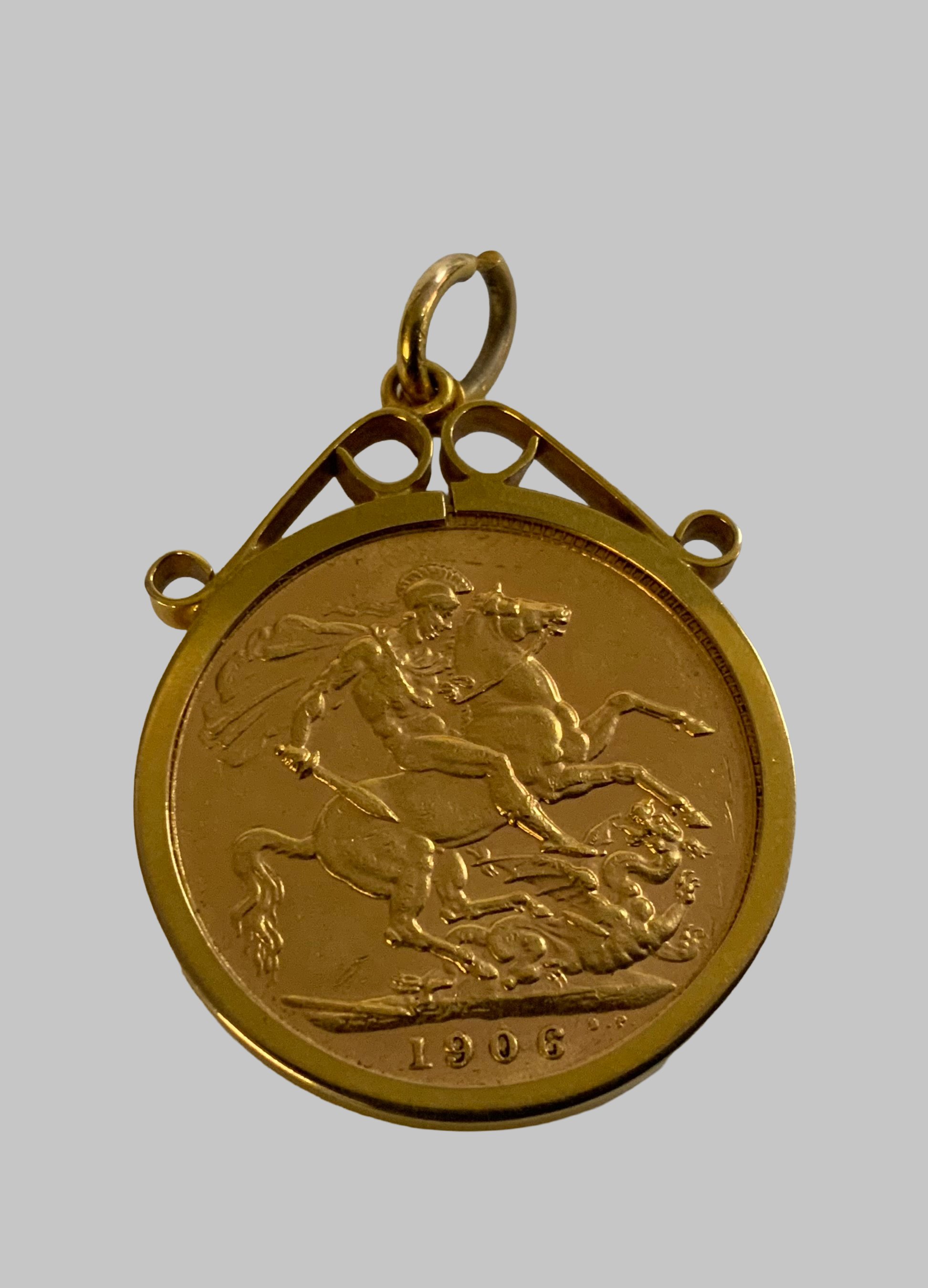 A 1906 Edward VII full sovereign in a 9ct gold coin mount. (A)