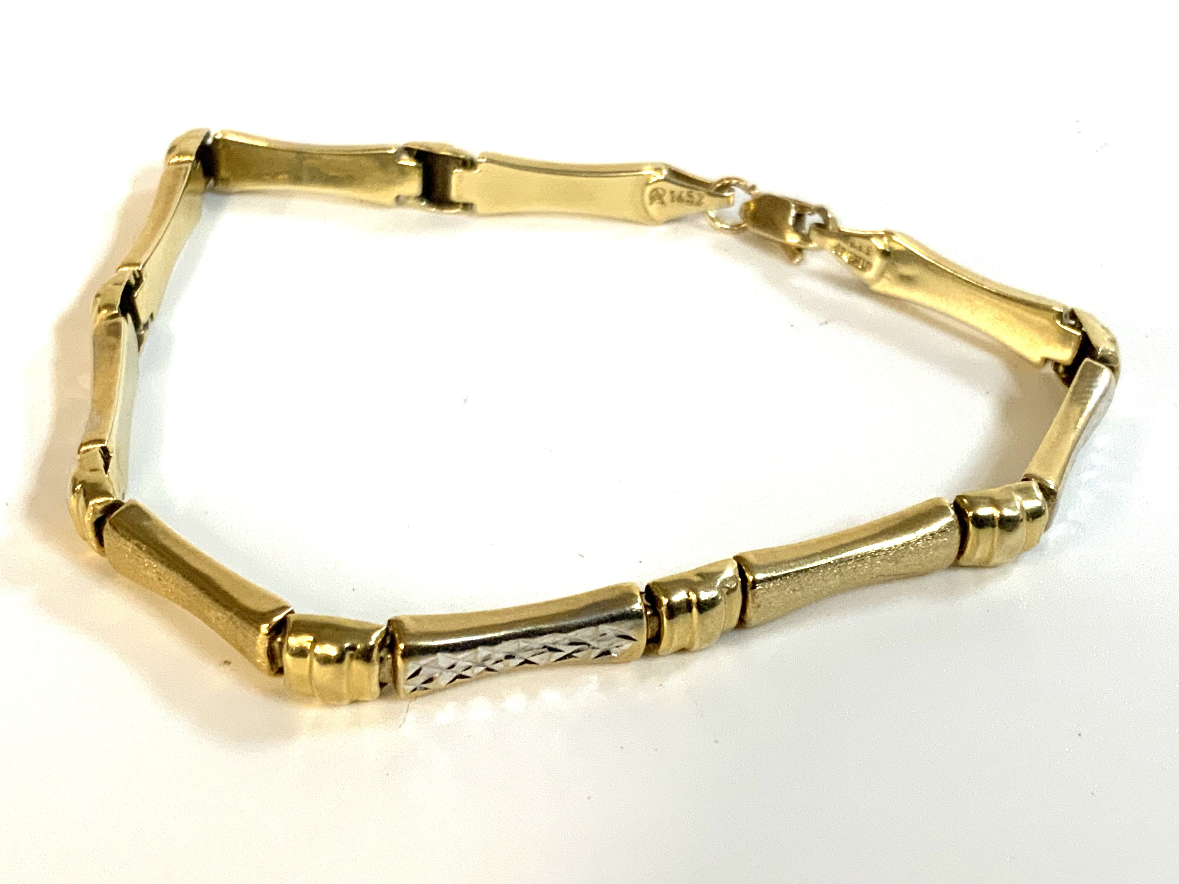 A yellow and white gold bracelet with makers mark, stamped 535 (14K) 19cm.