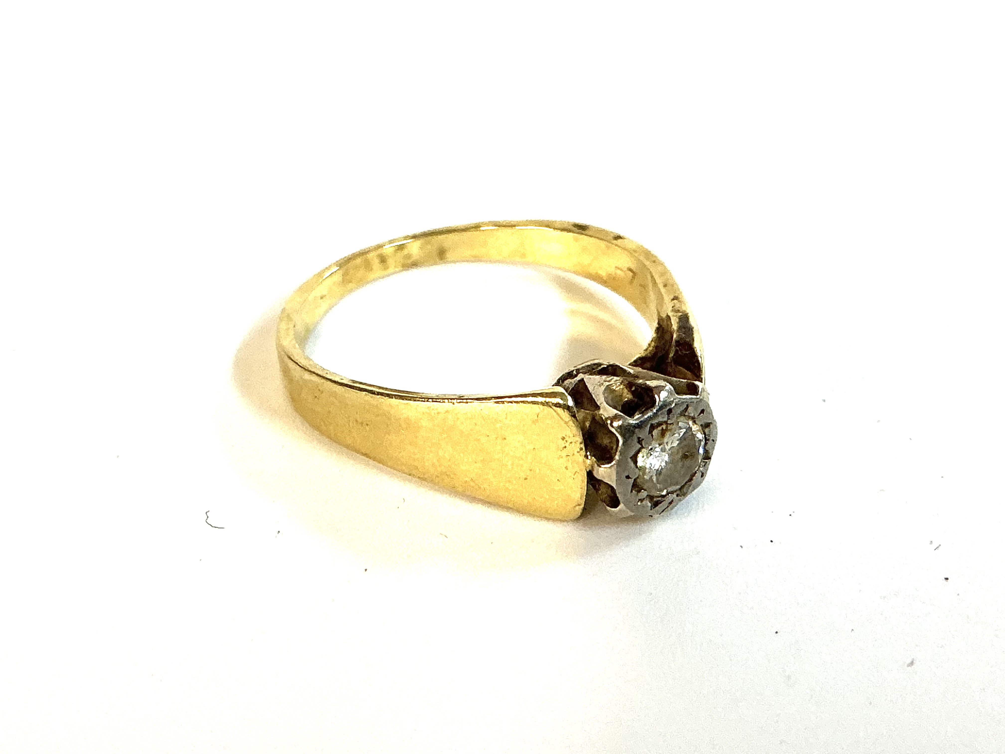 An unmarked 18ct yellow gold diamond solitaire ring. Size M. (A)