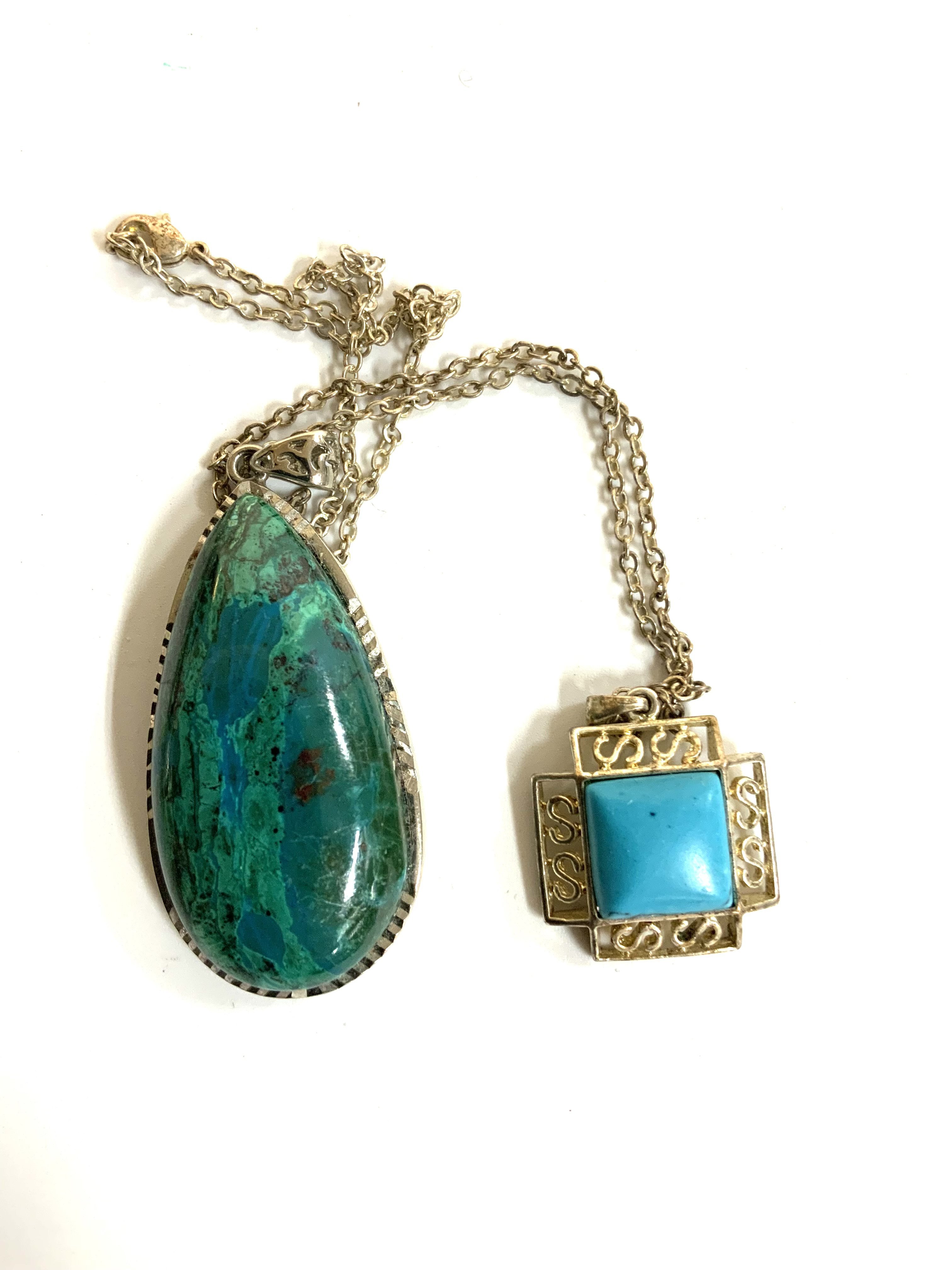2 sterling silver and turquoise pendants and chains.