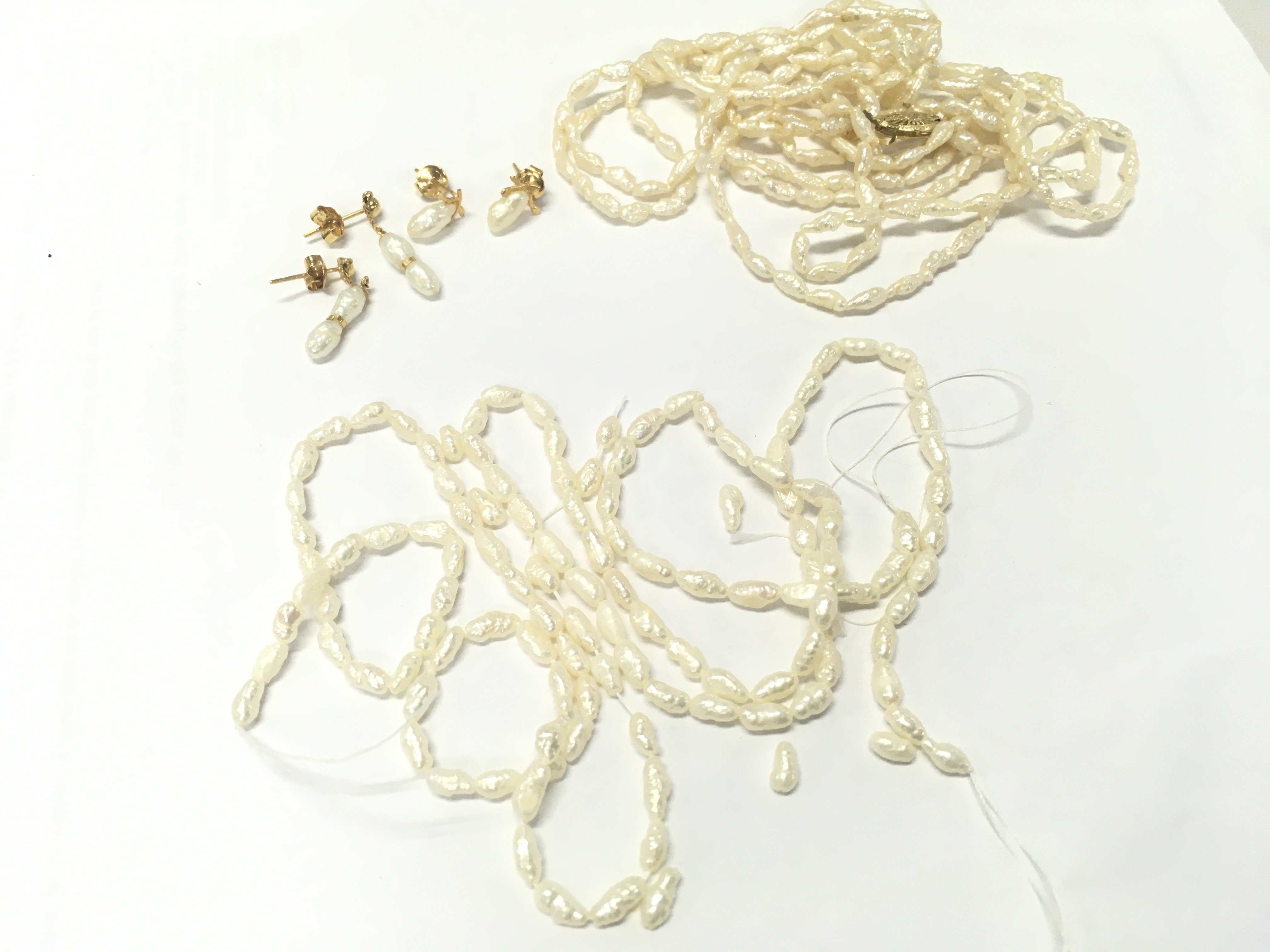 Withdrawn -A small collection of pearl jewellery . Necklace with a 14k clasp. Postage cat A