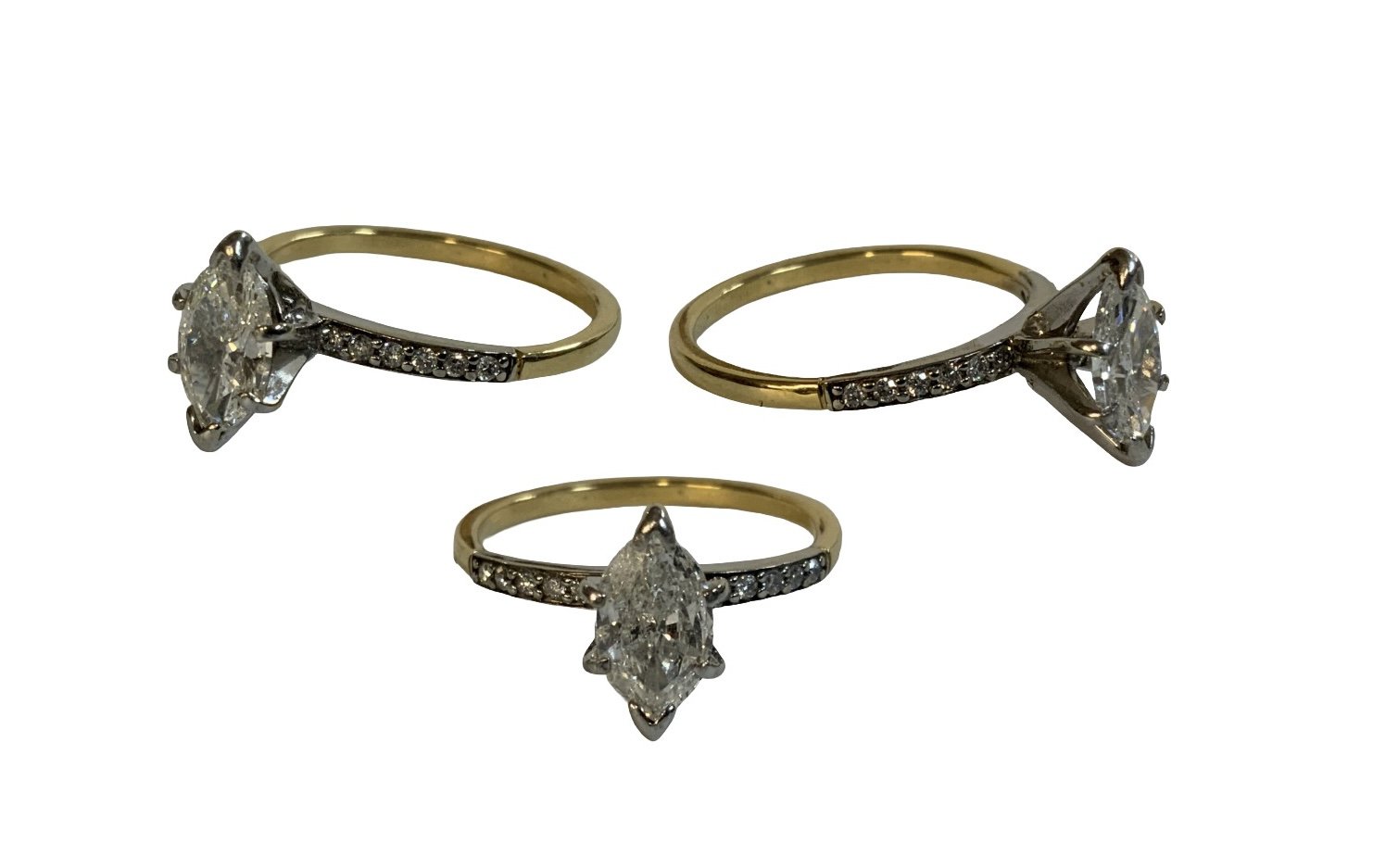 An 18ct yellow gold ring set with a marquise cut diamond solitaire, approximately 1.2ct, with diamonds inset into set shoulders. Size R.