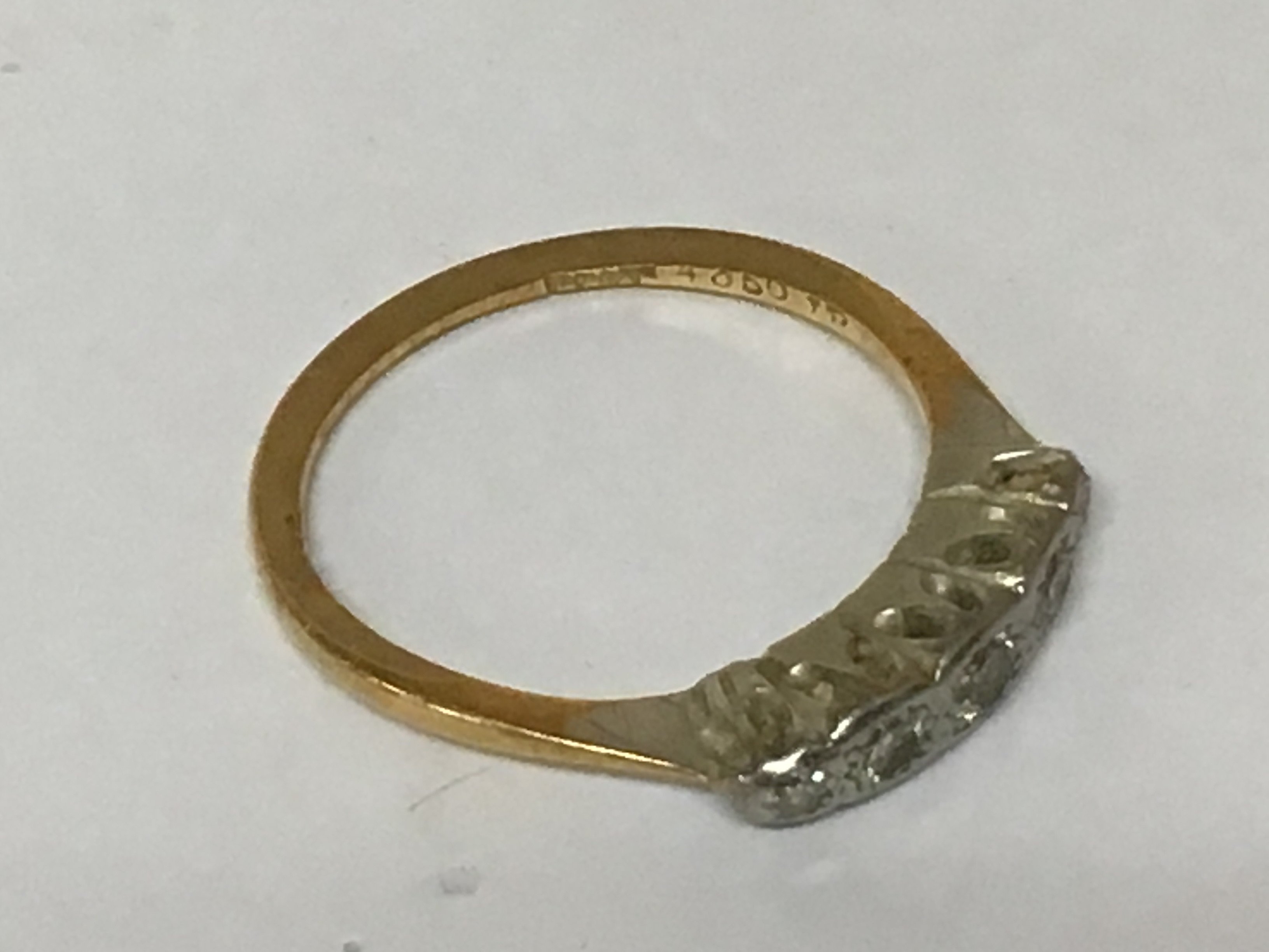 An 18carat gold ring set with five small diamonds. Weight 2g.