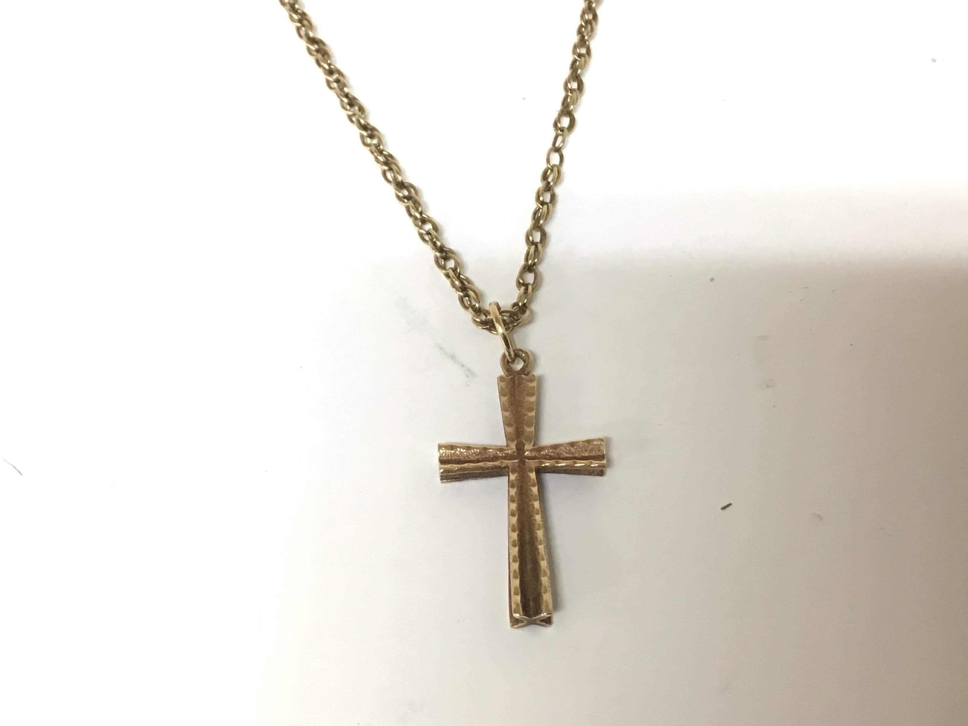 A 9carat gold cross and chain. Weight 6.4g