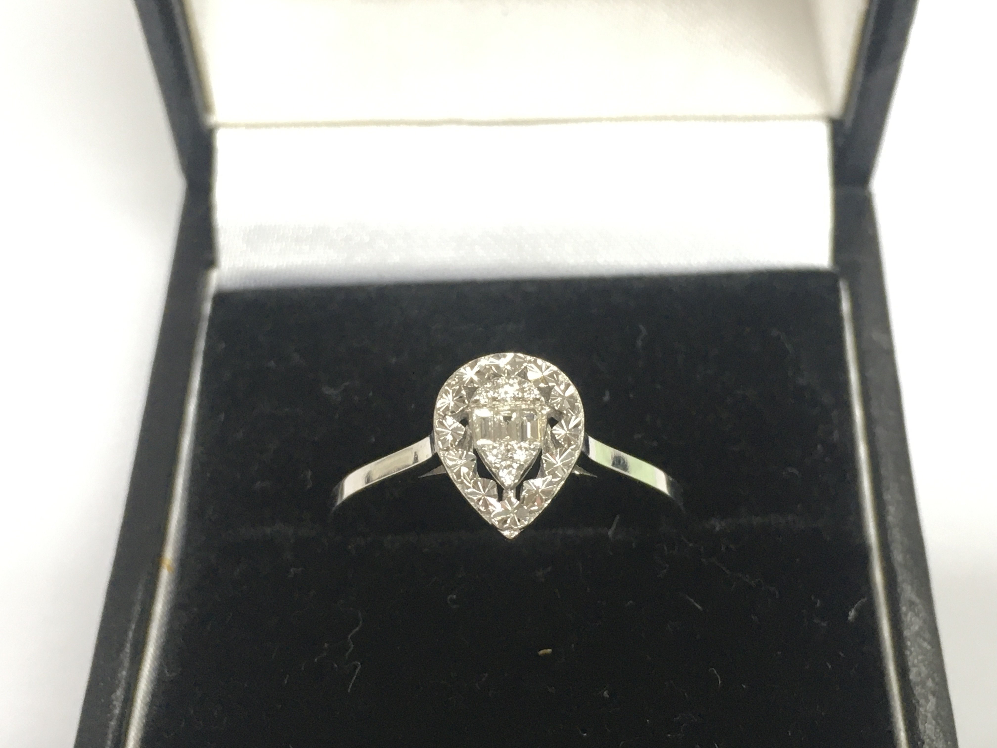 A 14ct white gold diamond cluster ring, approx 1.8g and approx size N. Shipping category A.