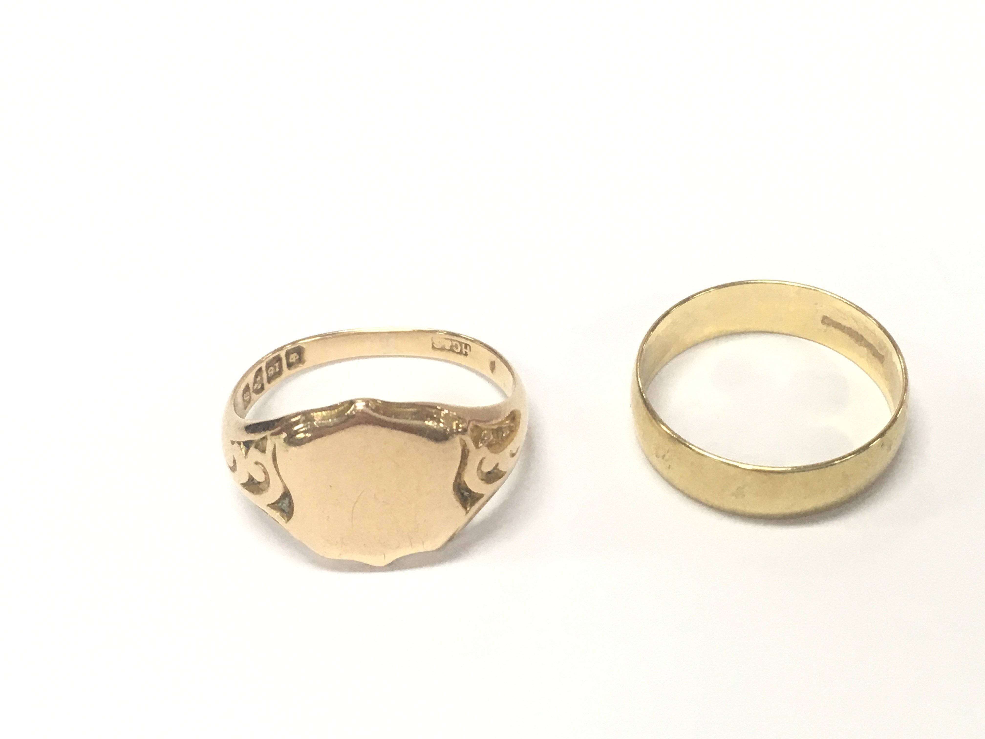 An 18ct signet ring 6.83g size R and an 18ct band size P 3g Postage A
