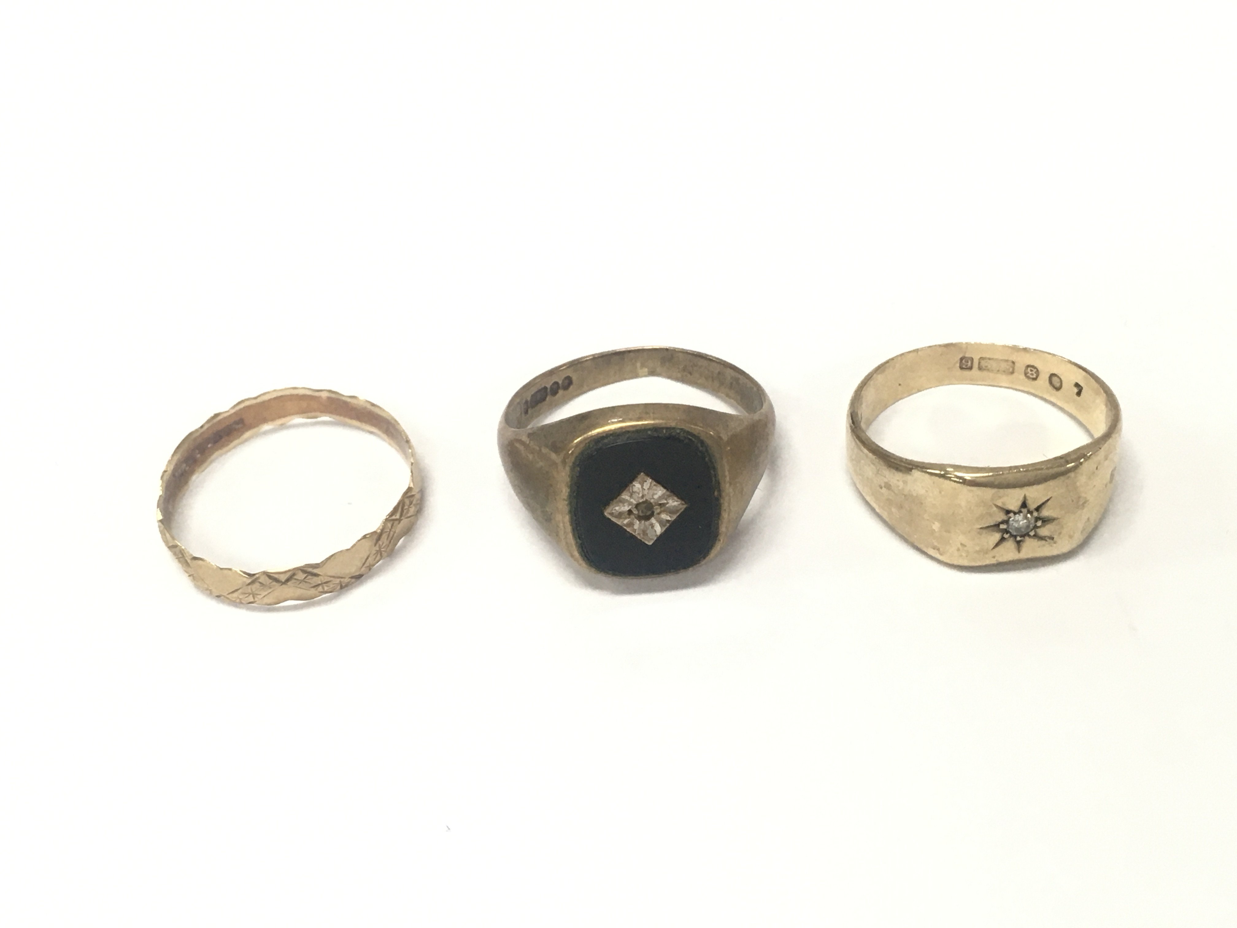 Three 9ct gold rings of various designs. Approximately 10.17g