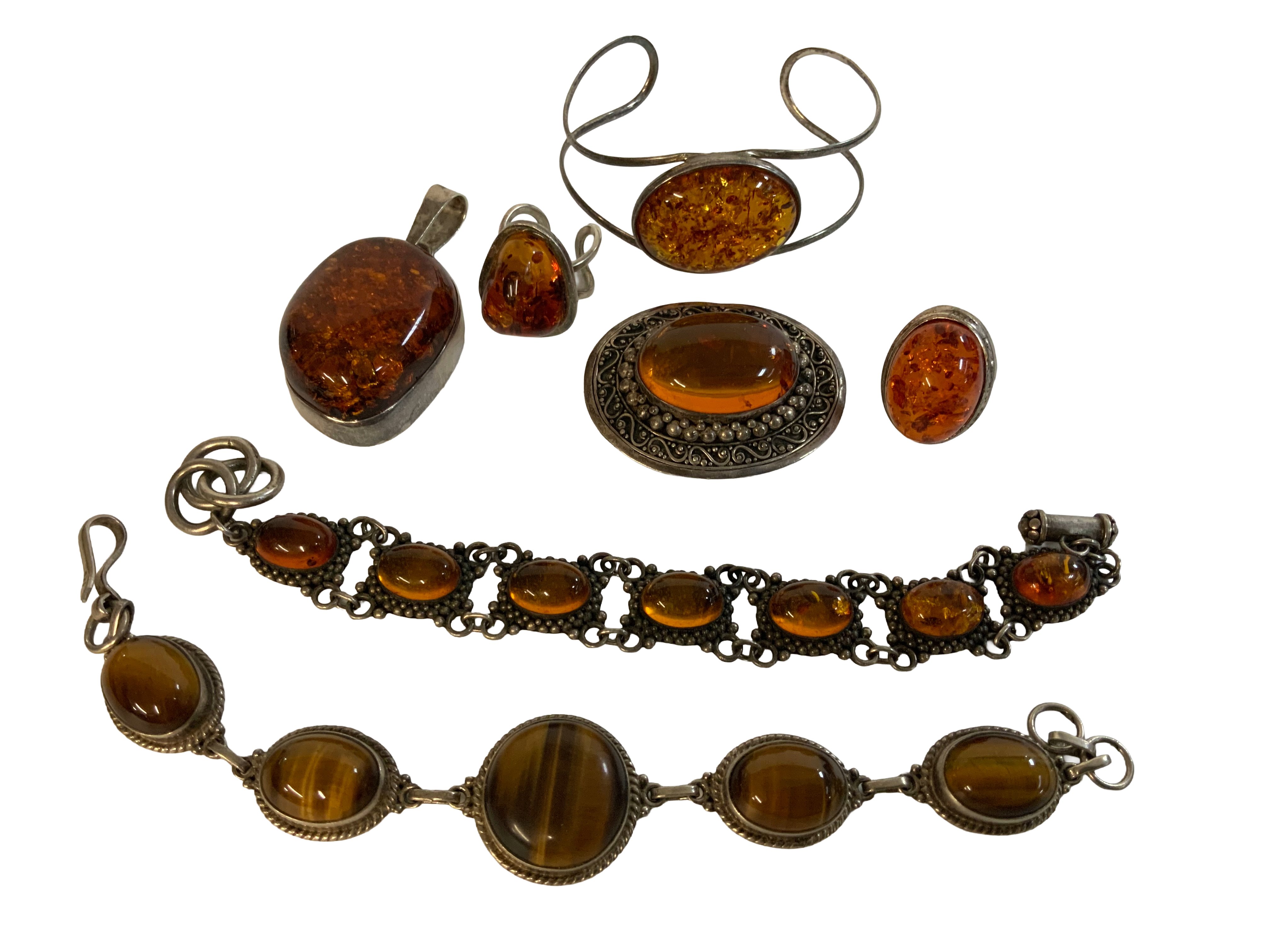 a mixed collection of sterling silver and amber jewellery including a tigers eye bracelet.