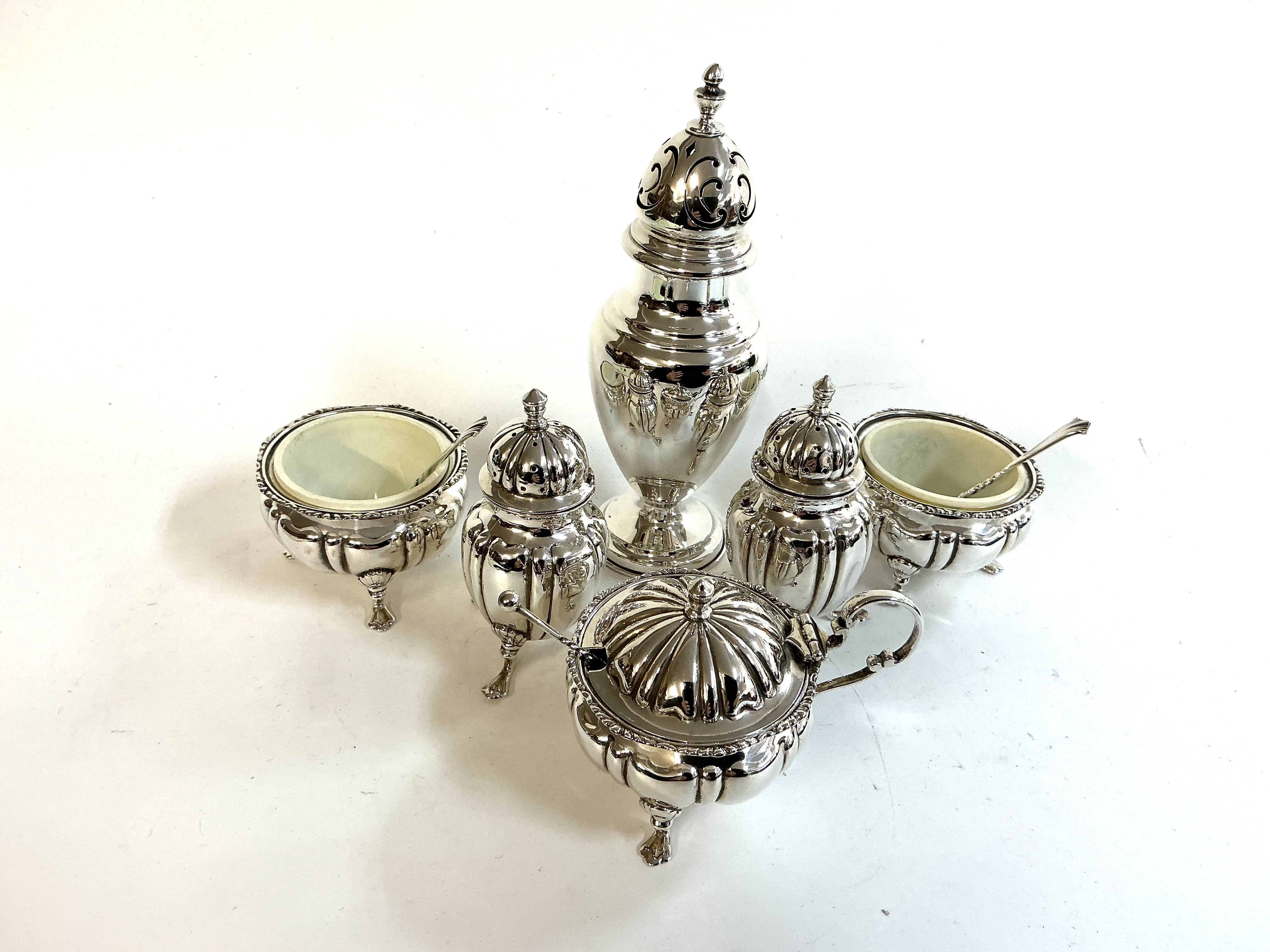 A small hallmarked silver sugar caster together with a 5 piece hallmarked silver cruet set.