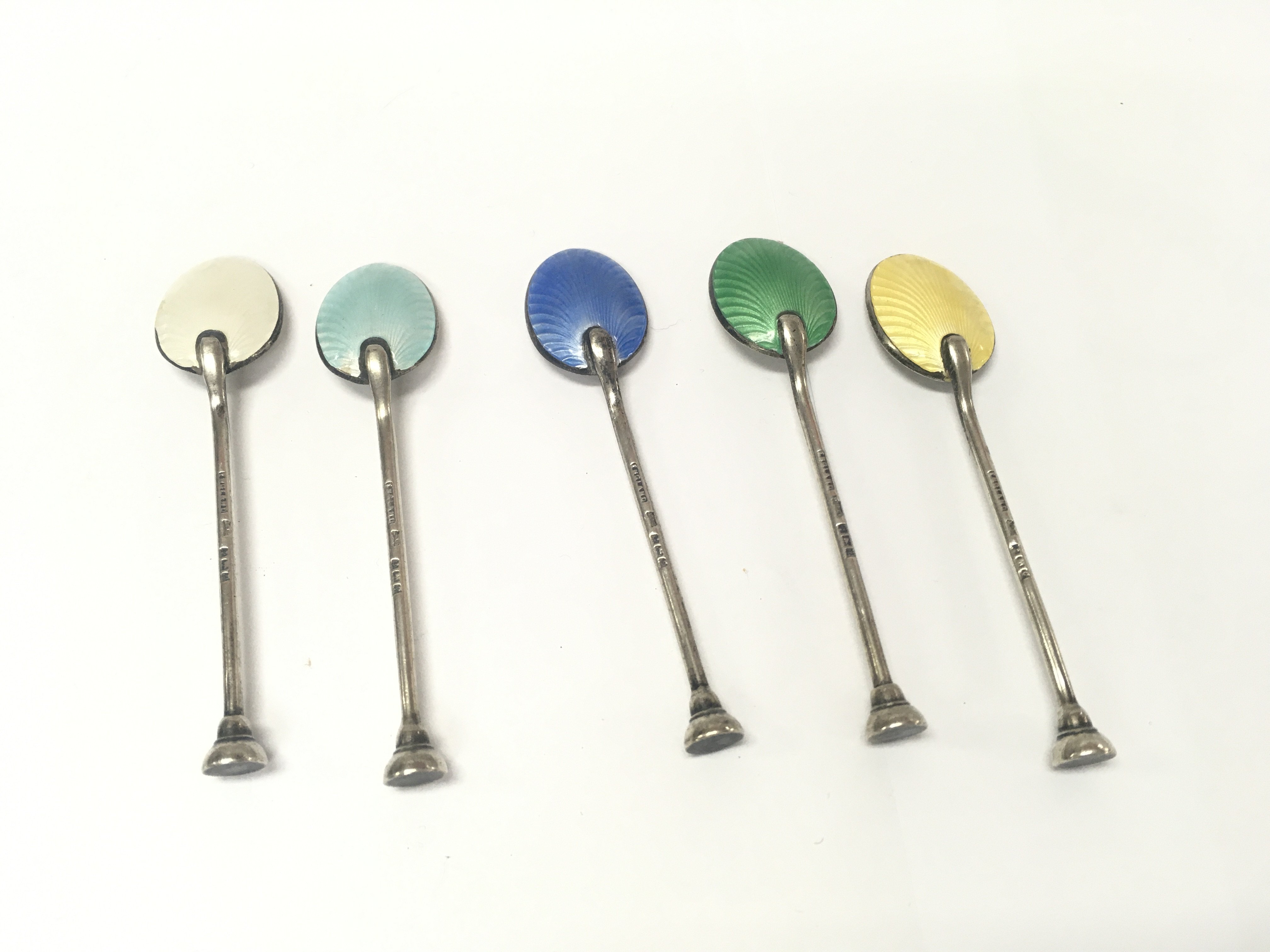 Five silver and enamel spoons. Approximately 35g