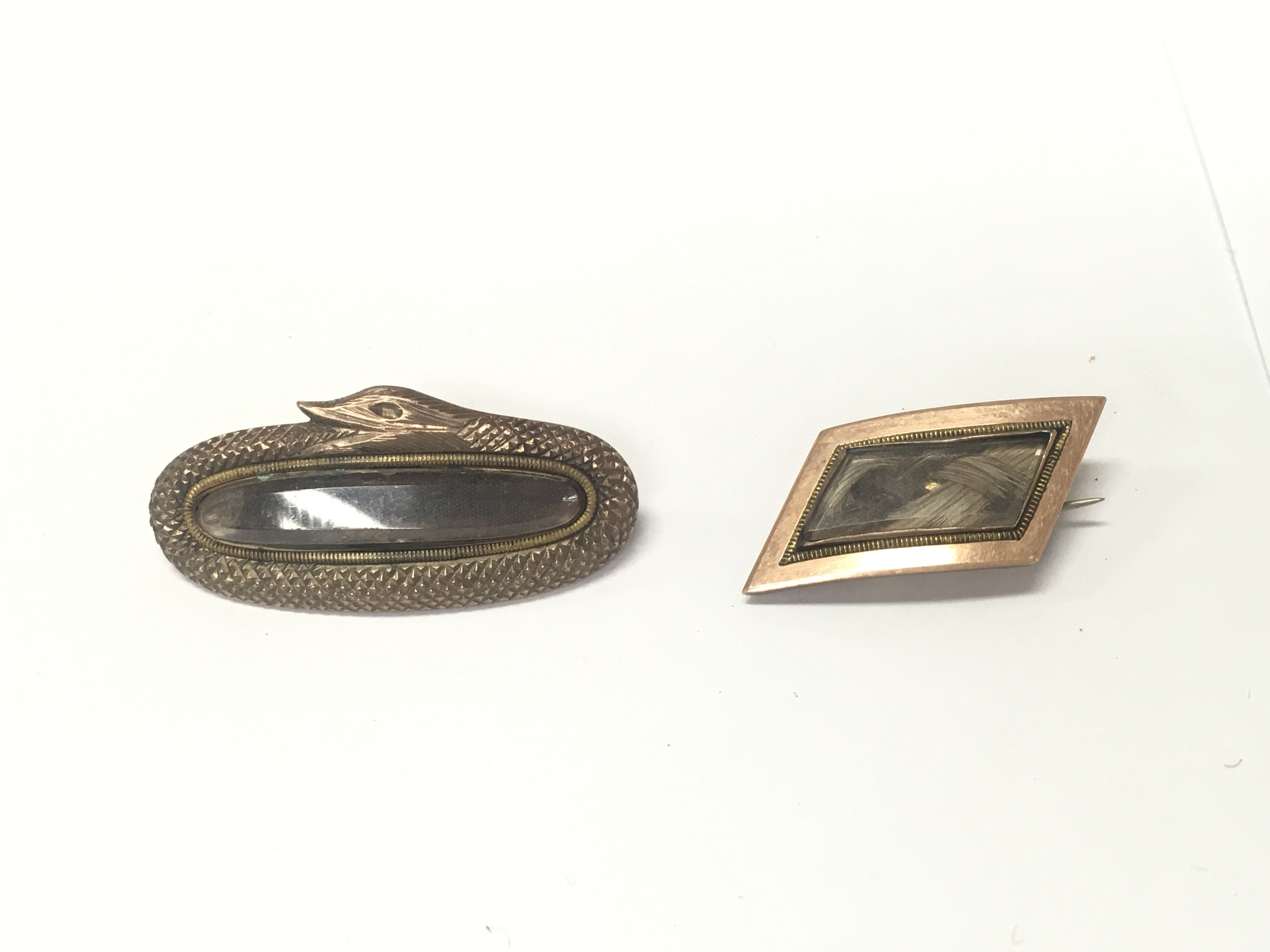 Two quality unmarked yellow metal mourning brooches.