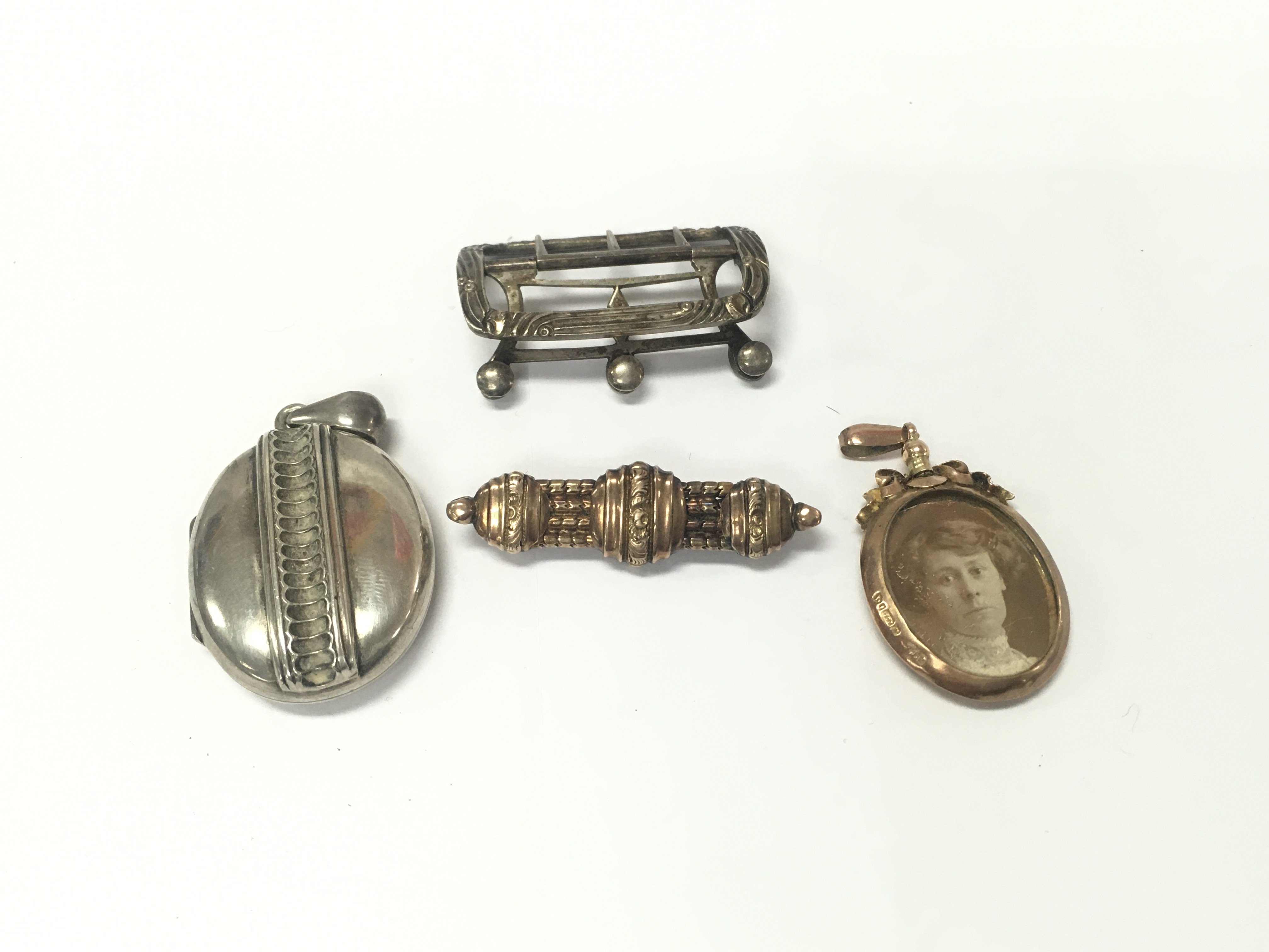 An 9ct gold oval locket 6.75g along with a silver buckle and other items.