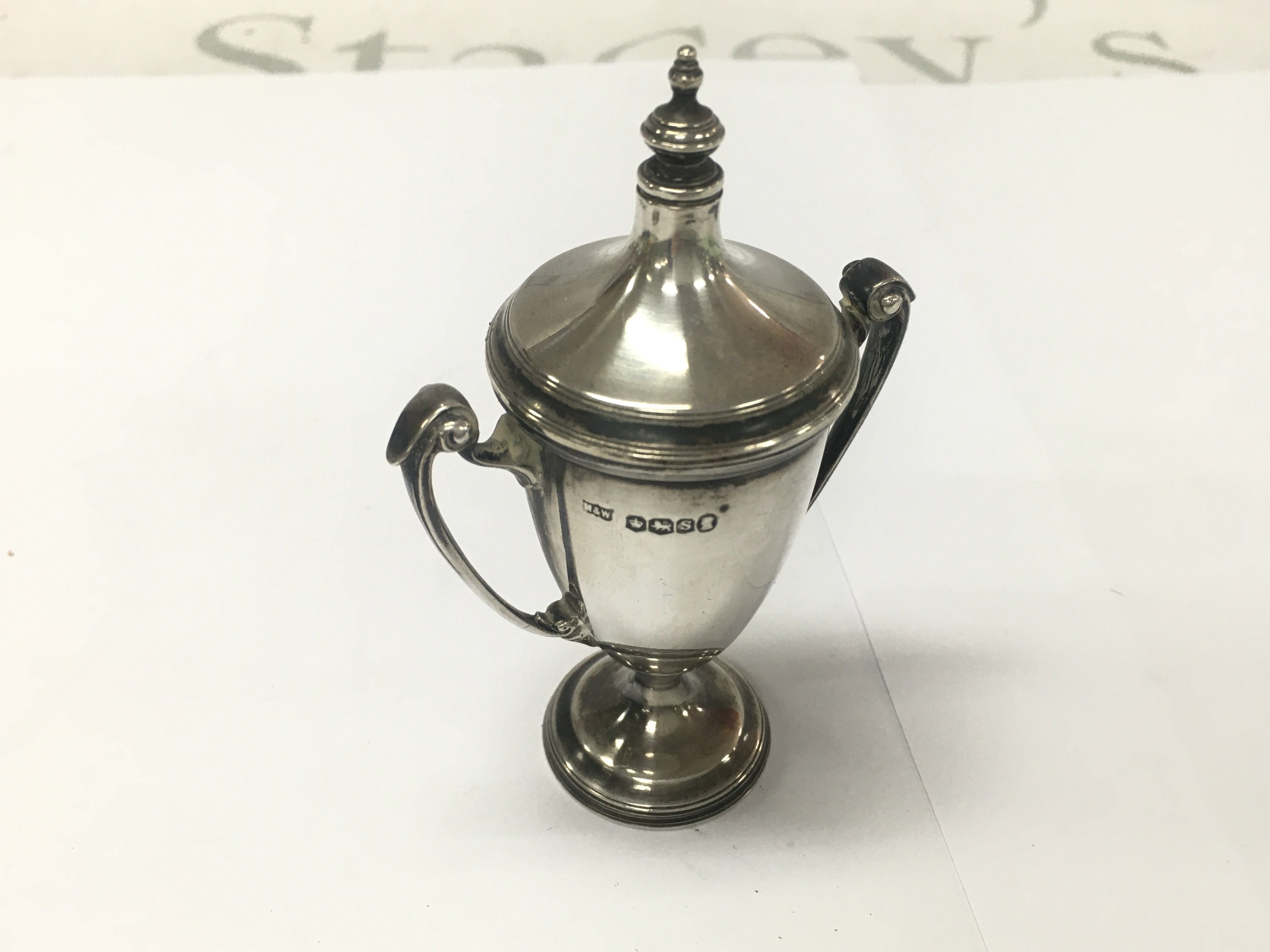 A small silver trophy cup. Approximately 57g and 10cm tall.