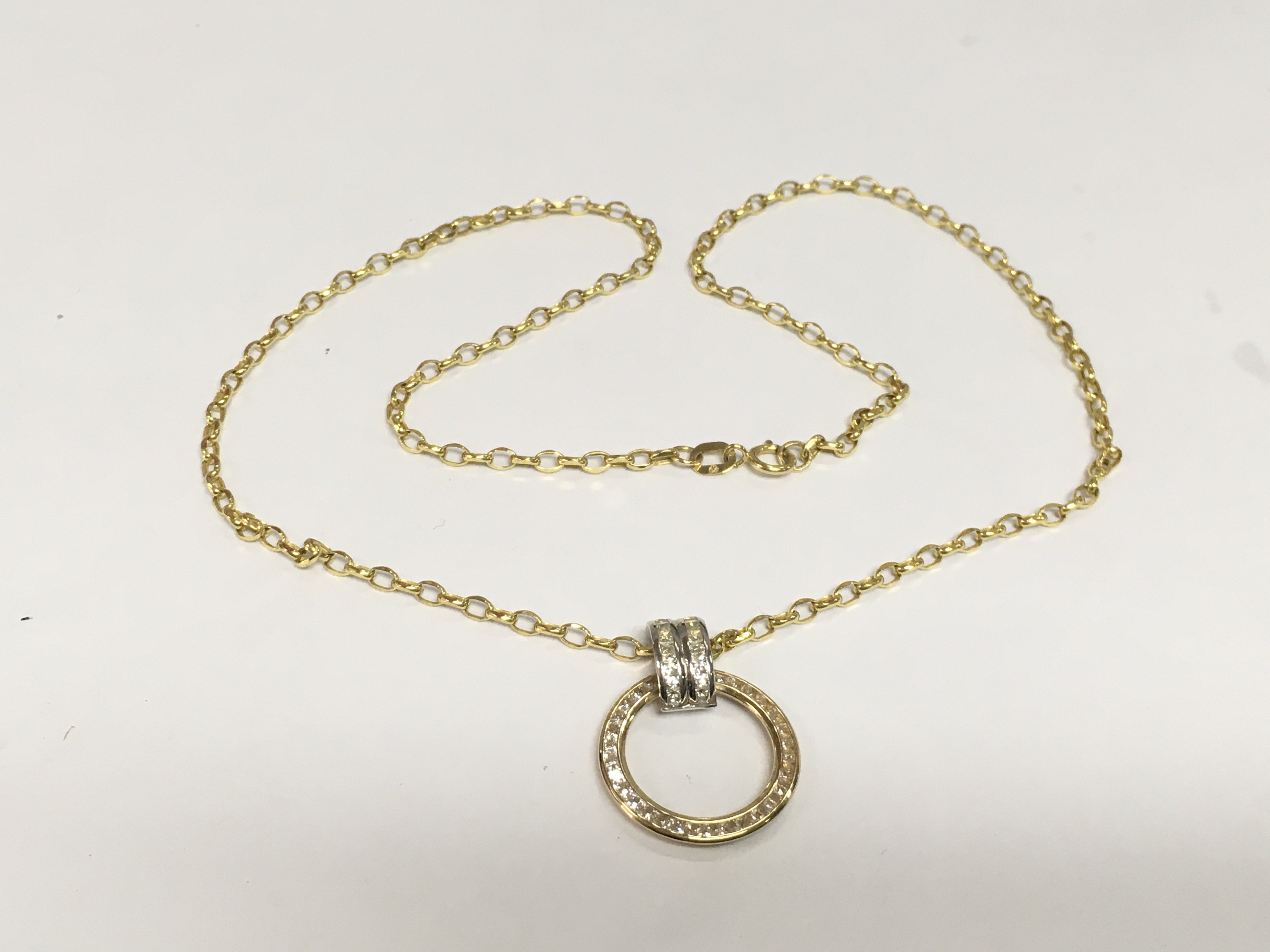 A 9ct gold circular pendant on a 9ct gold chain, approx 2.5g. Shipping category A.