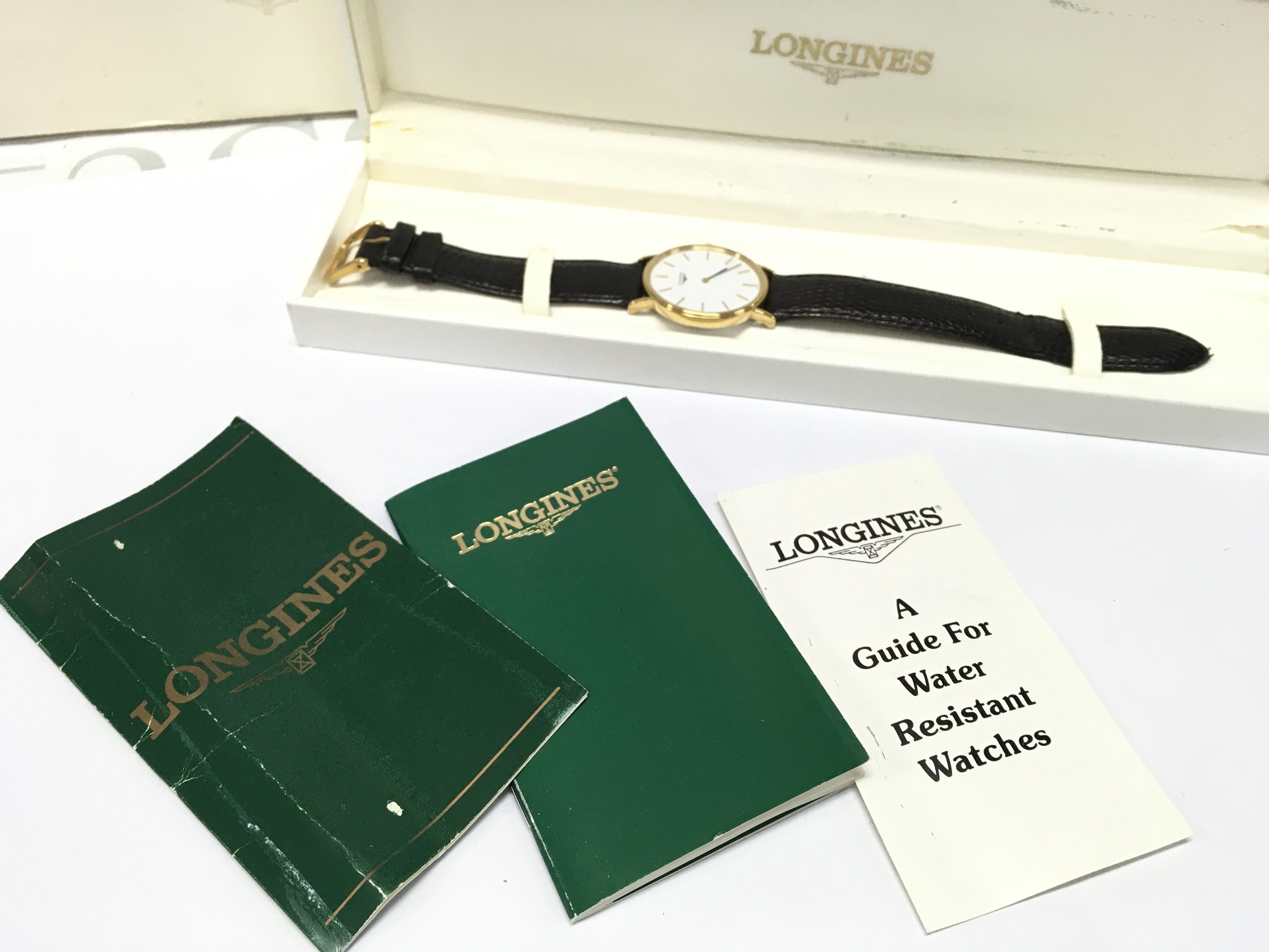 A mens Longines watch, boxed with paperwork . Postage category b