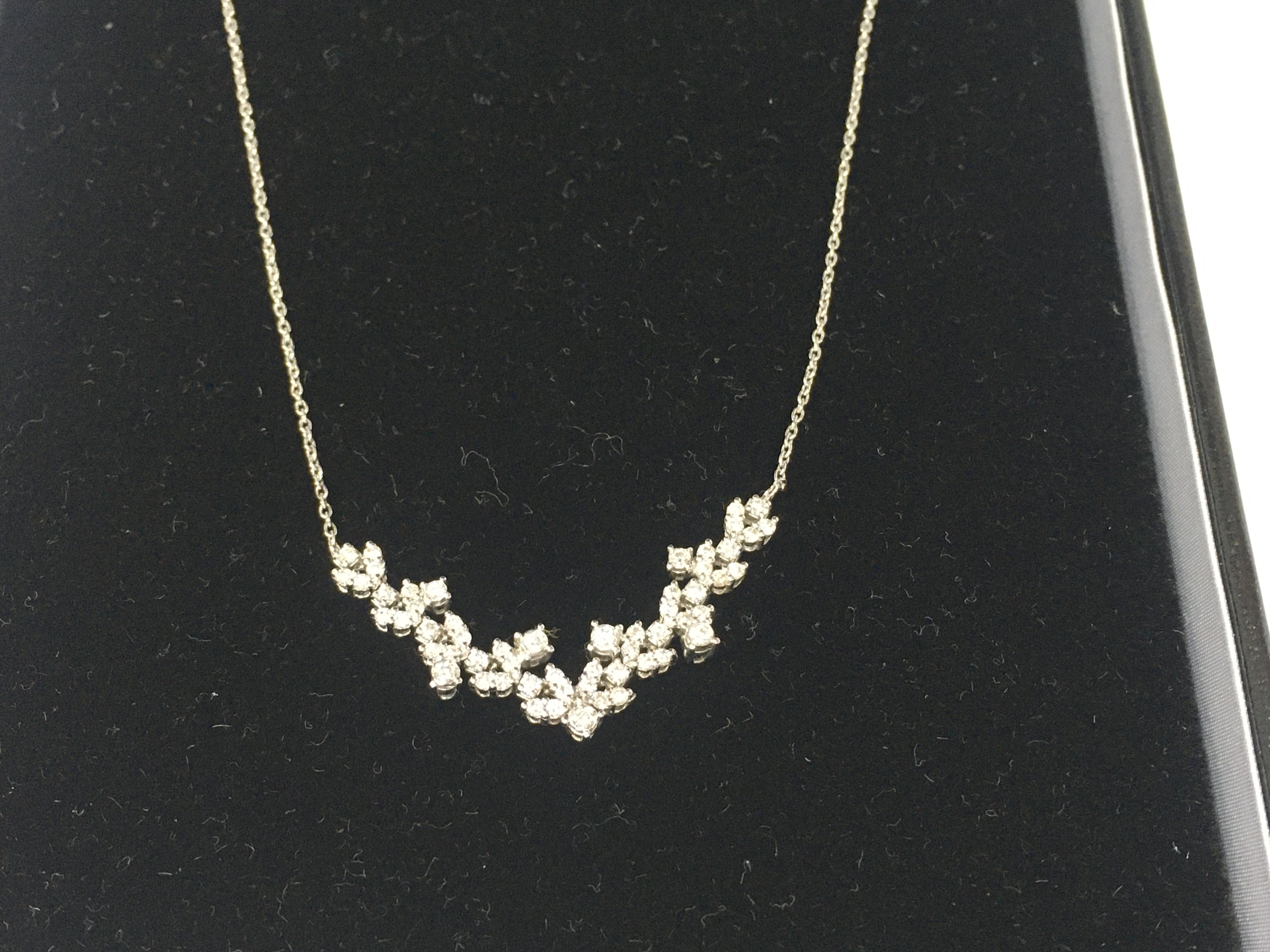 A 14ct white gold diamond cluster necklace. 4.30g approximately.