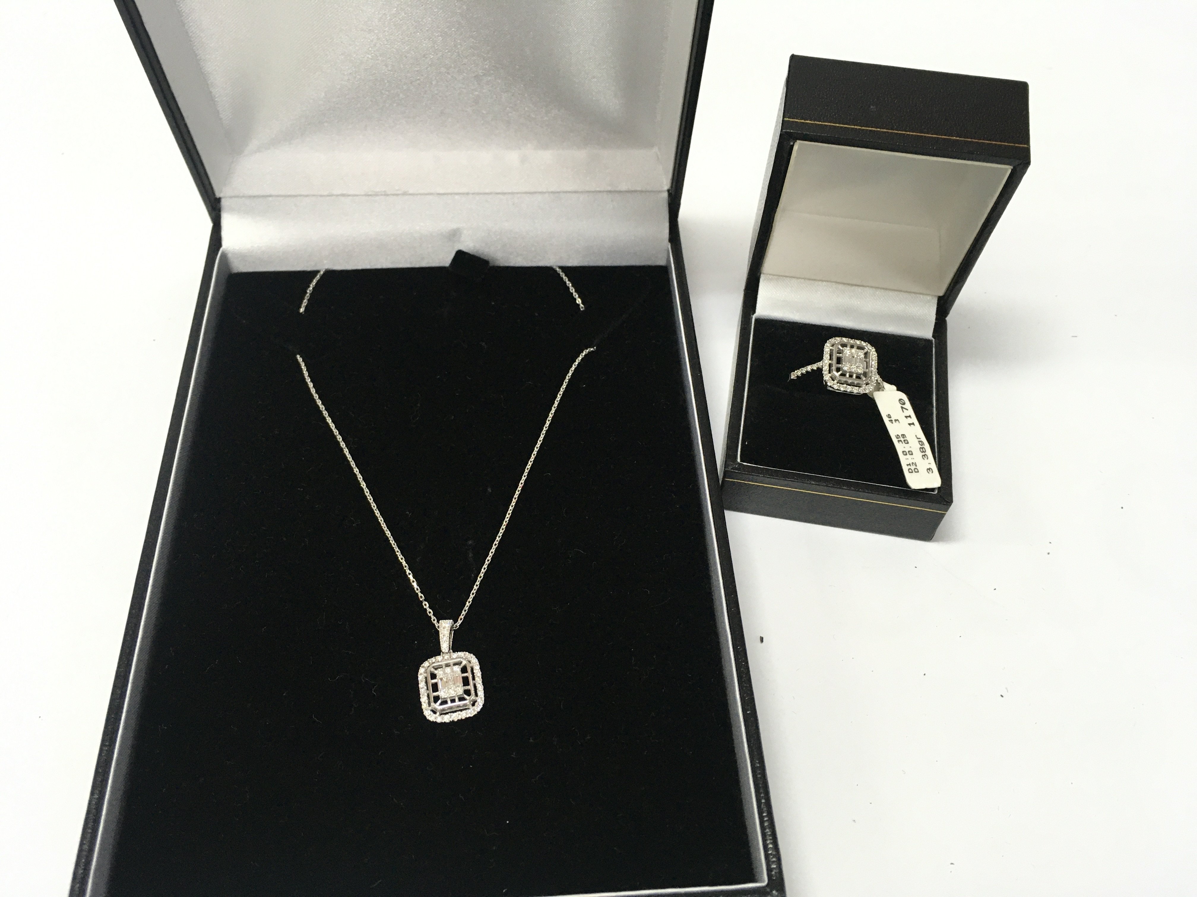 A 14ct white gold and diamond pendant chain and ring. Ring is size N
