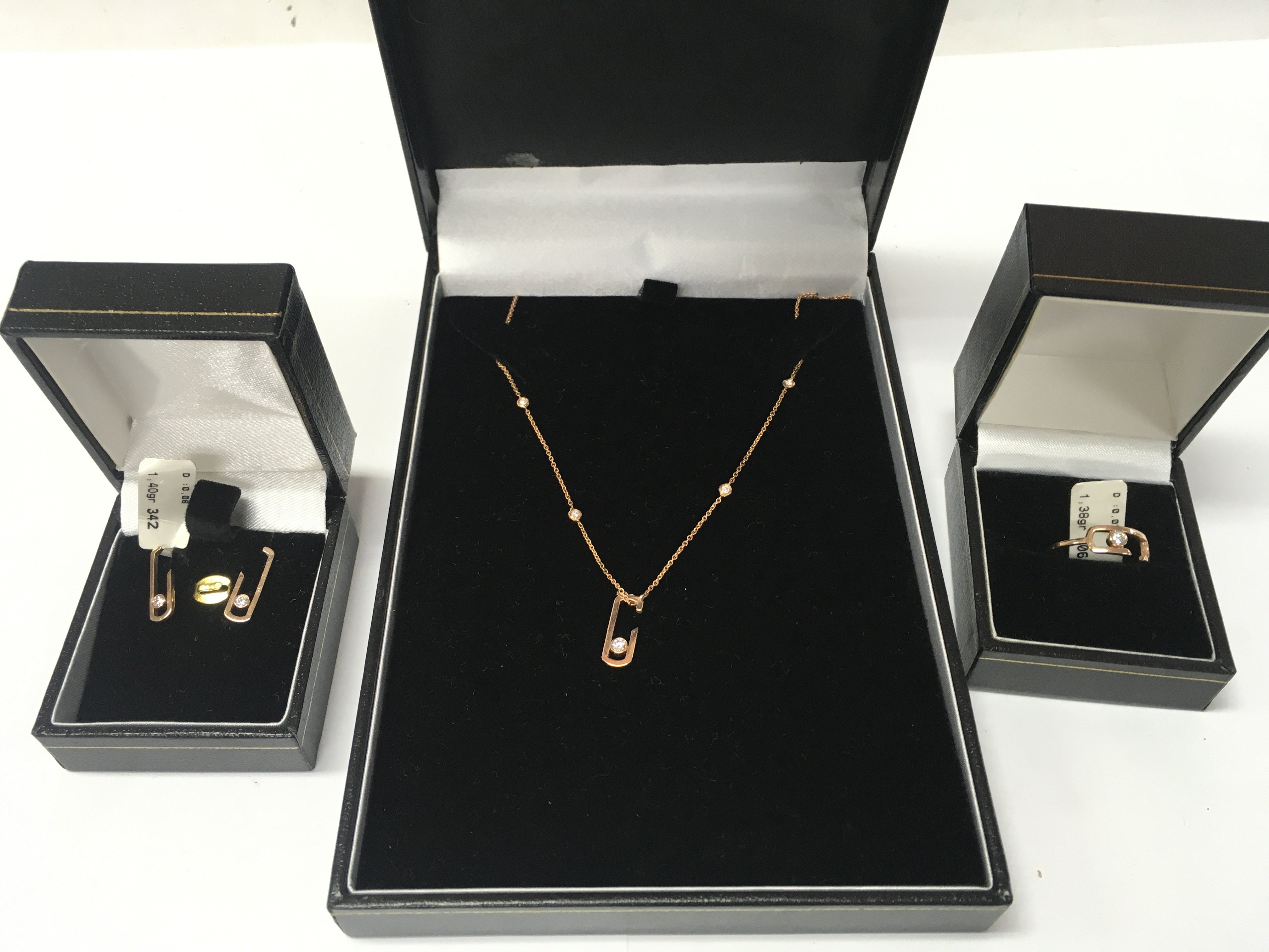 A 14ct rose gold and diamond jewellery suite. Ring size N