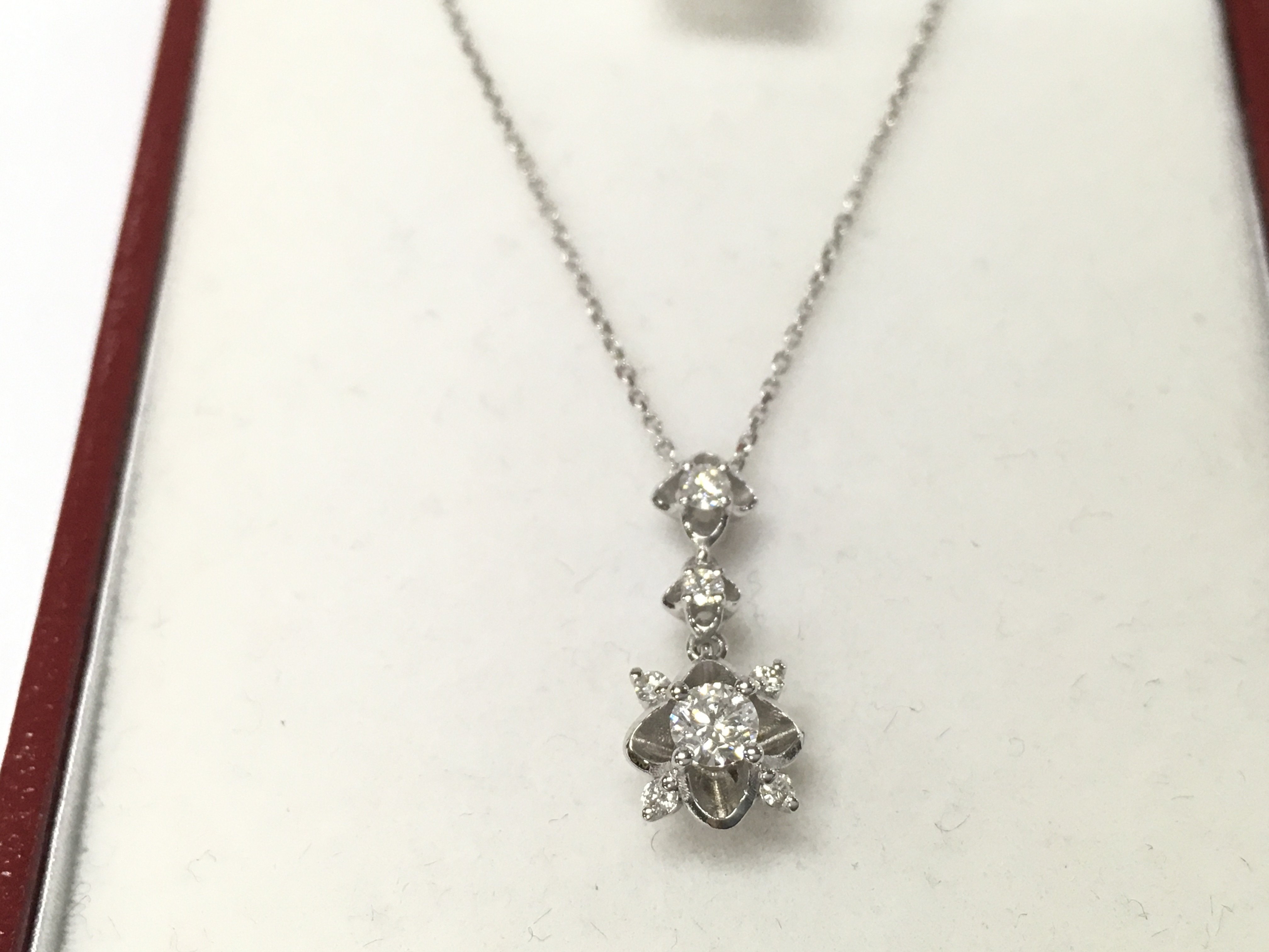 A 14ct white gold diamond solitaire necklace. Postage B