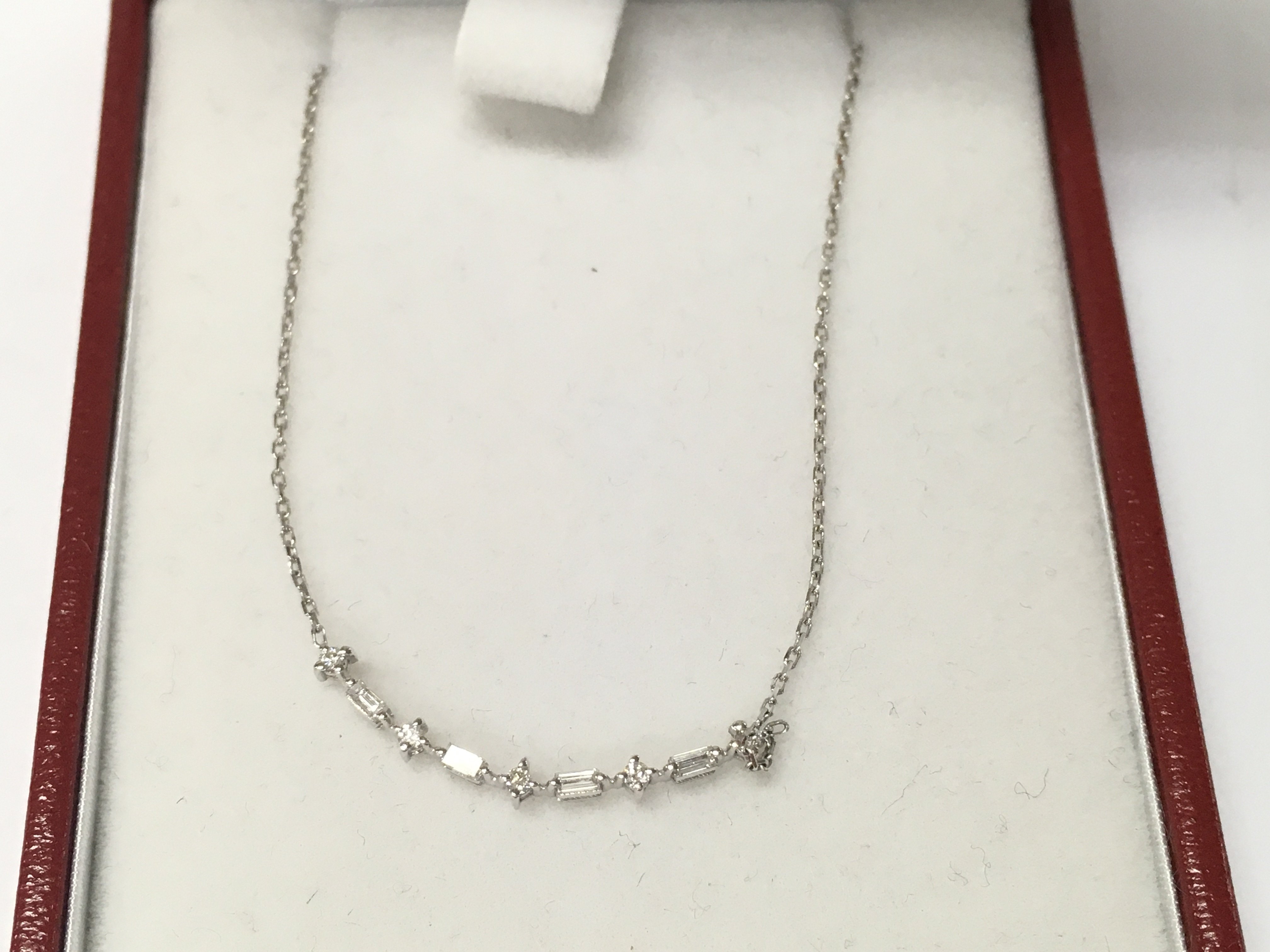 A 14ct white gold row diamond necklace.