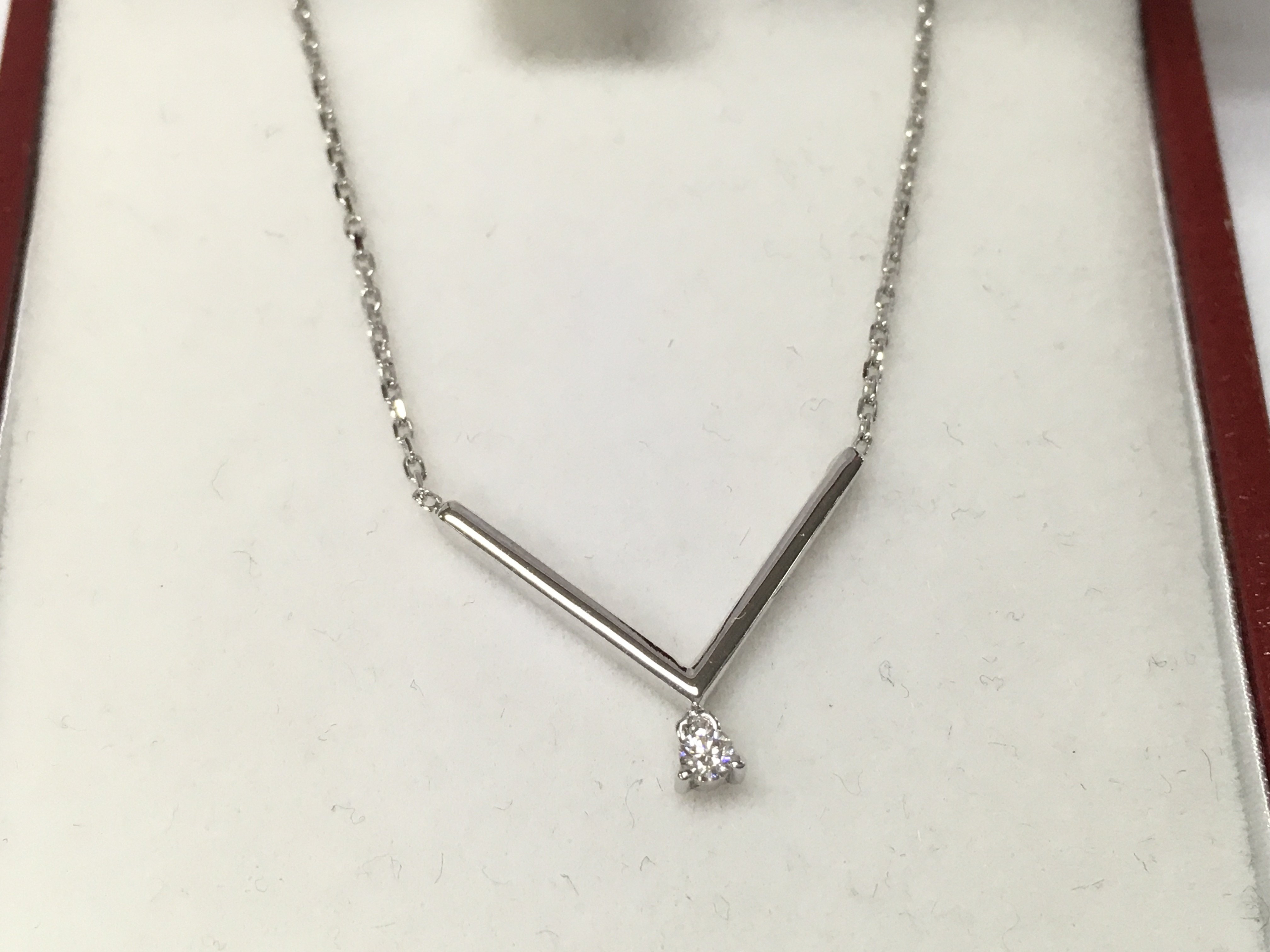 A 14ct white gold diamond v necklace.