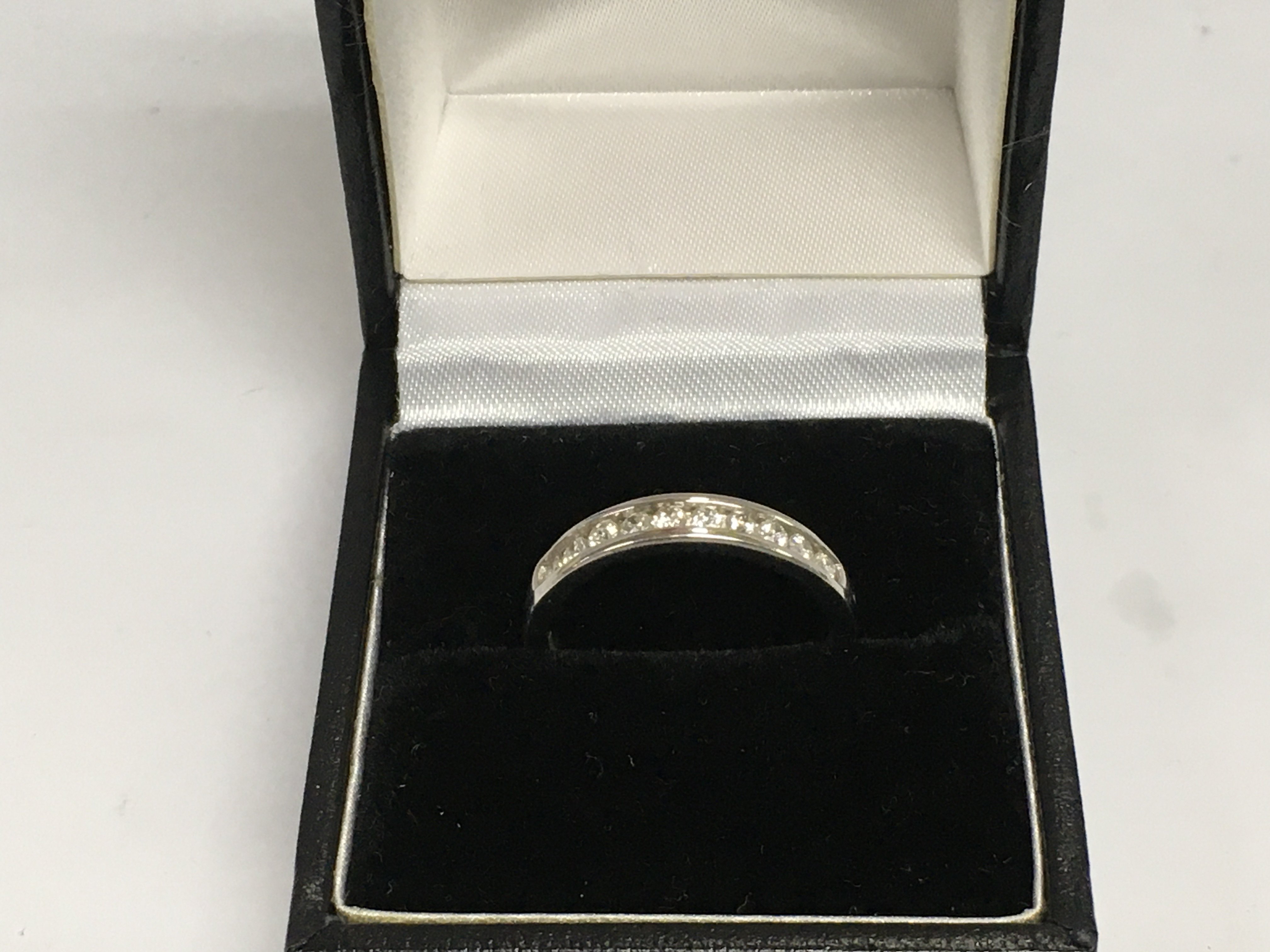 A 9ct white gold diamond eternity ring, approx 2.4g and approx size N-O. Shipping category A.