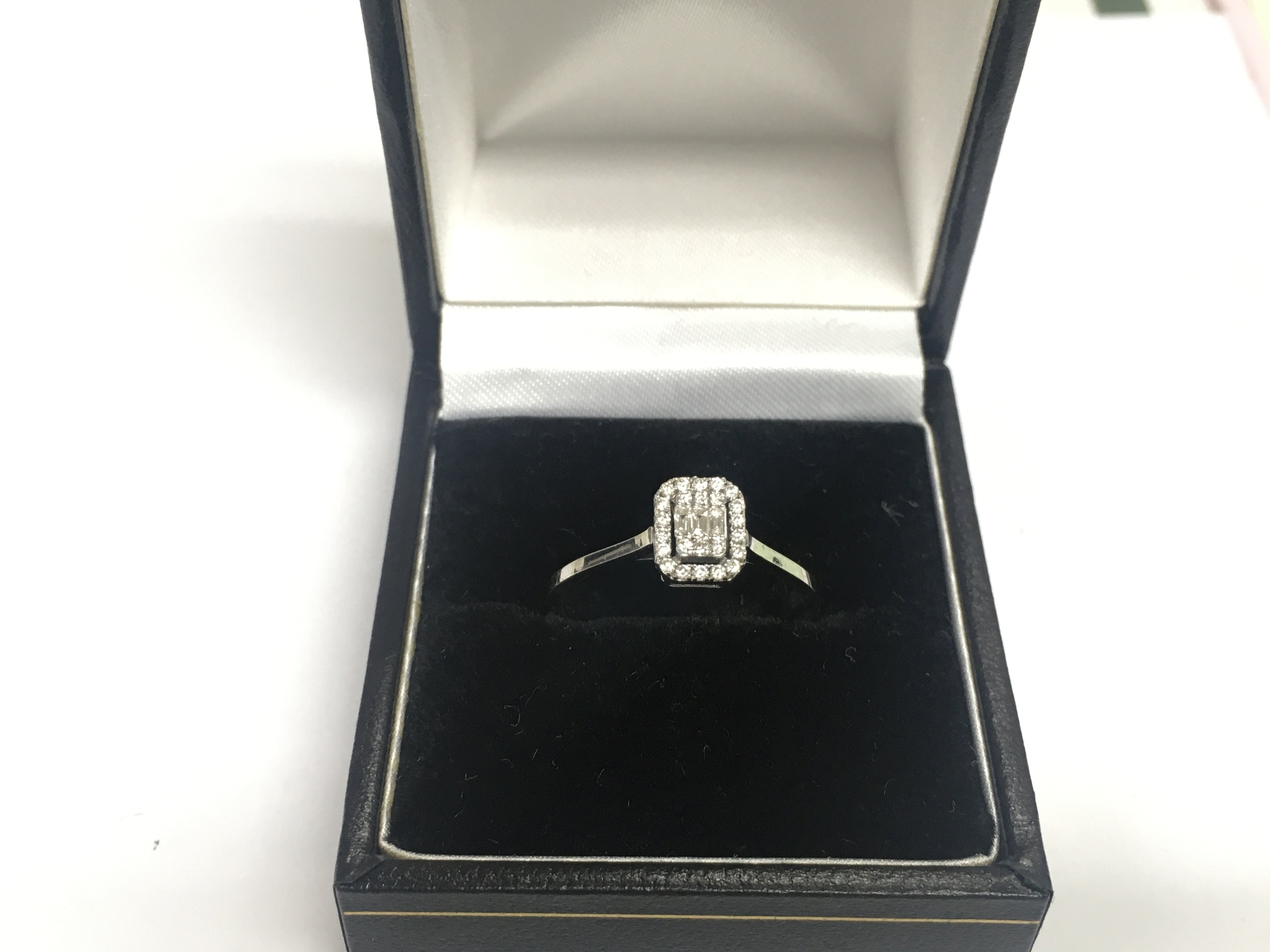 A 14ct white gold diamond cluster ring, approx 1.7g and approx size M-N. Shipping category A.