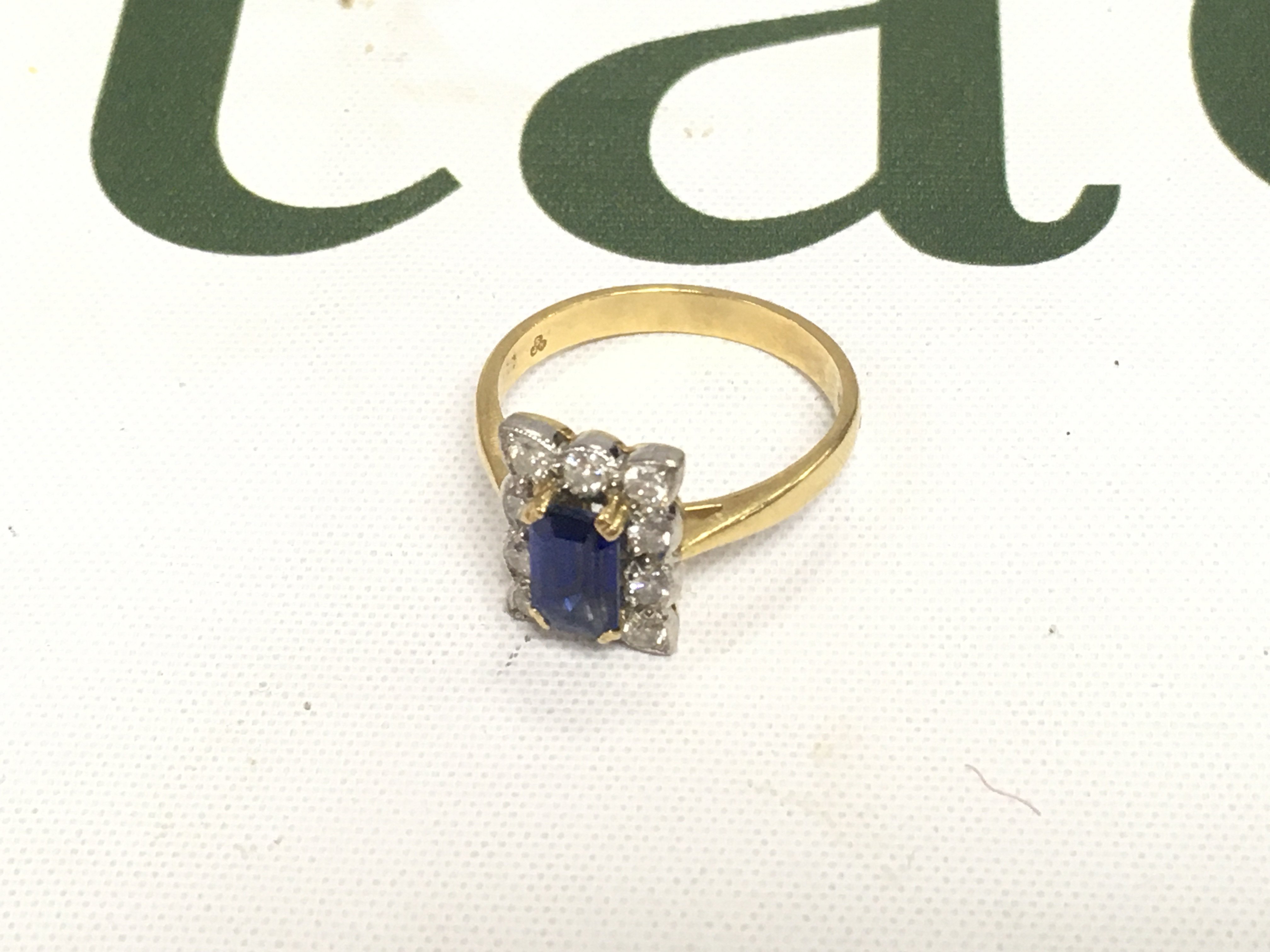 An 18ct diamond and sapphire ring Approx weight 4.19 grams, size O.