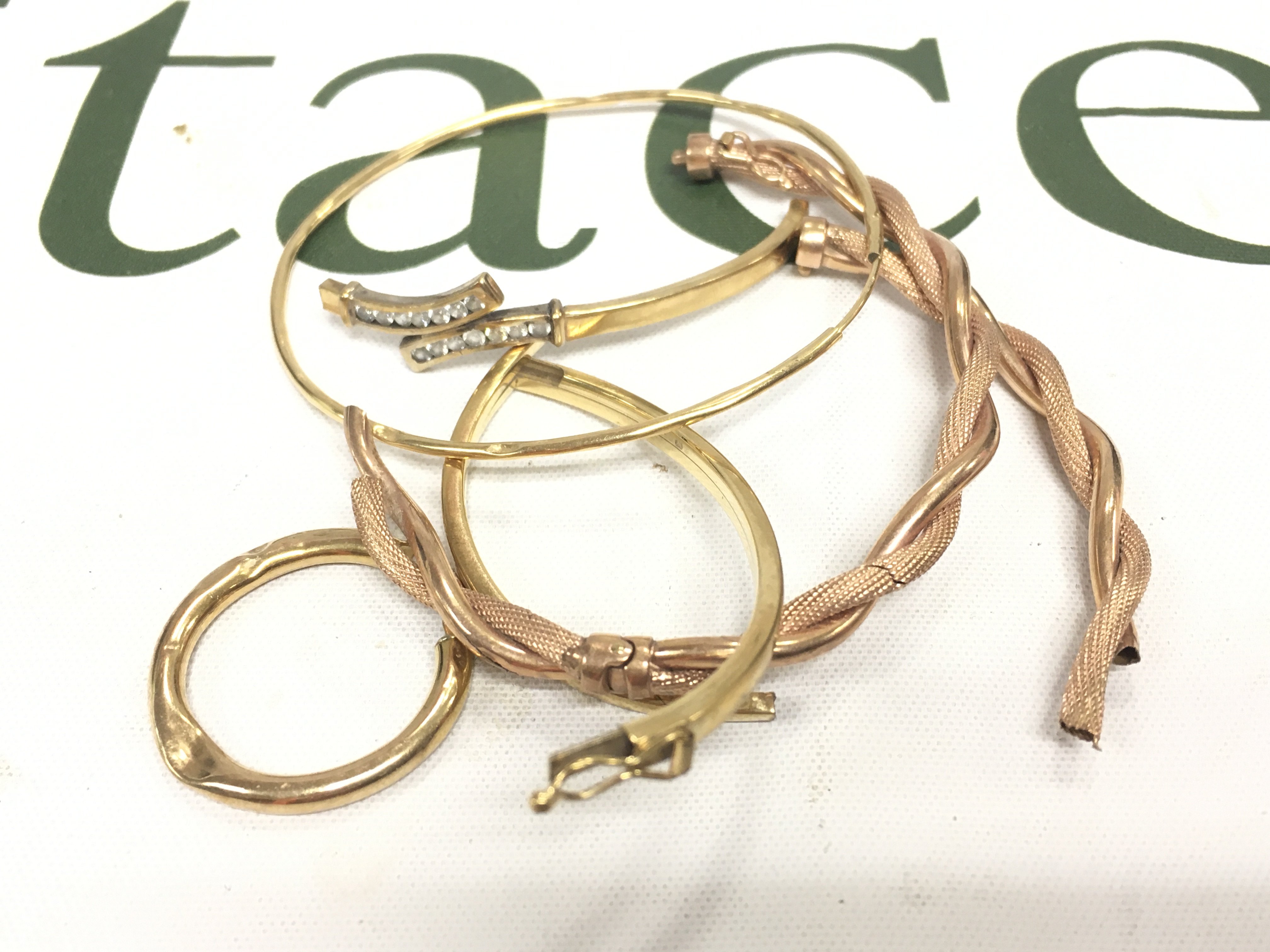 A collection of 9ct gold damaged bangles and a 9ct gold hoop. Approx weight 13 grams.