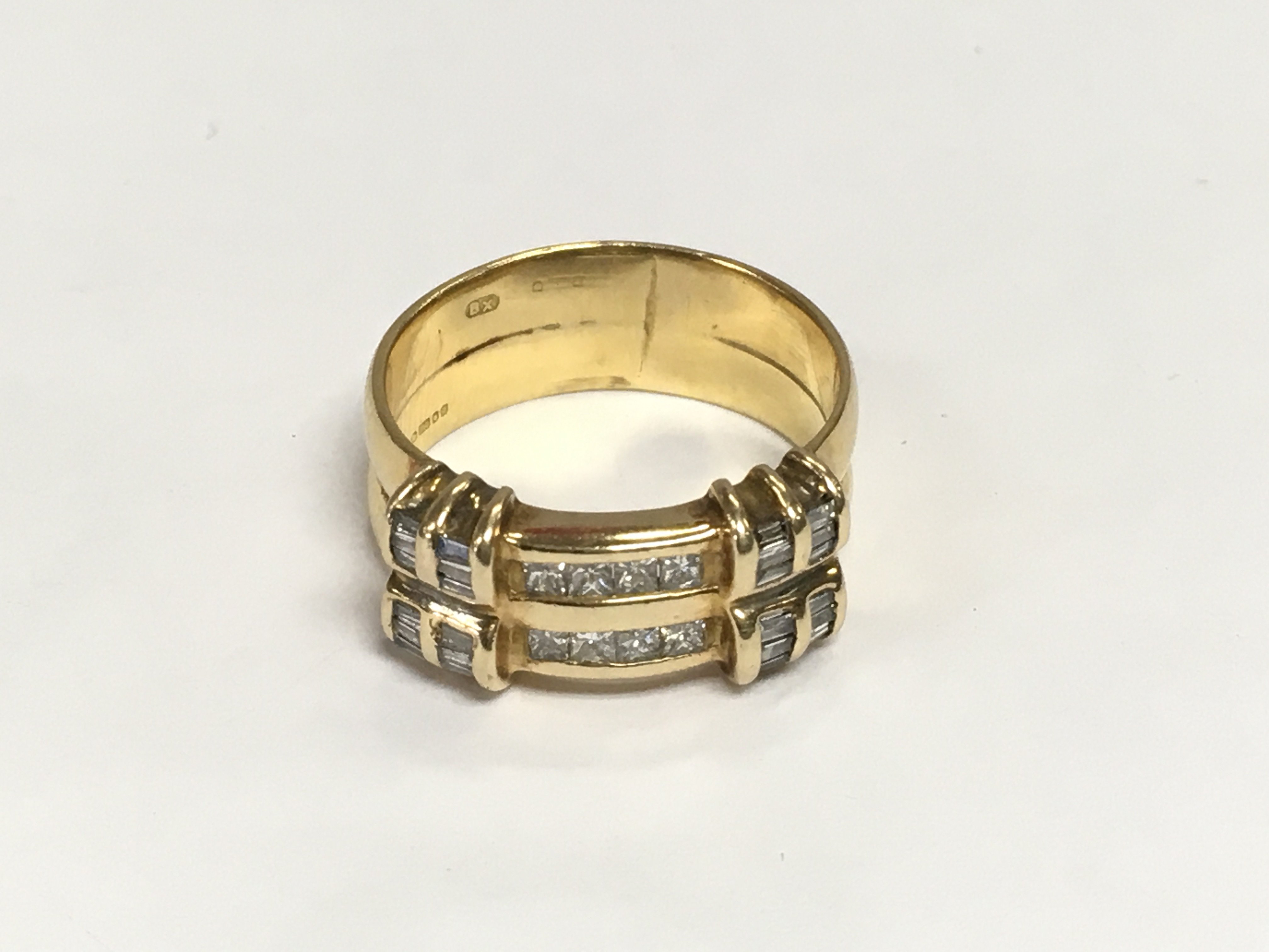 An 18ct gold double band ring set with sixteen diamonds, approx 7g and approx size O-P. Shipping category A.