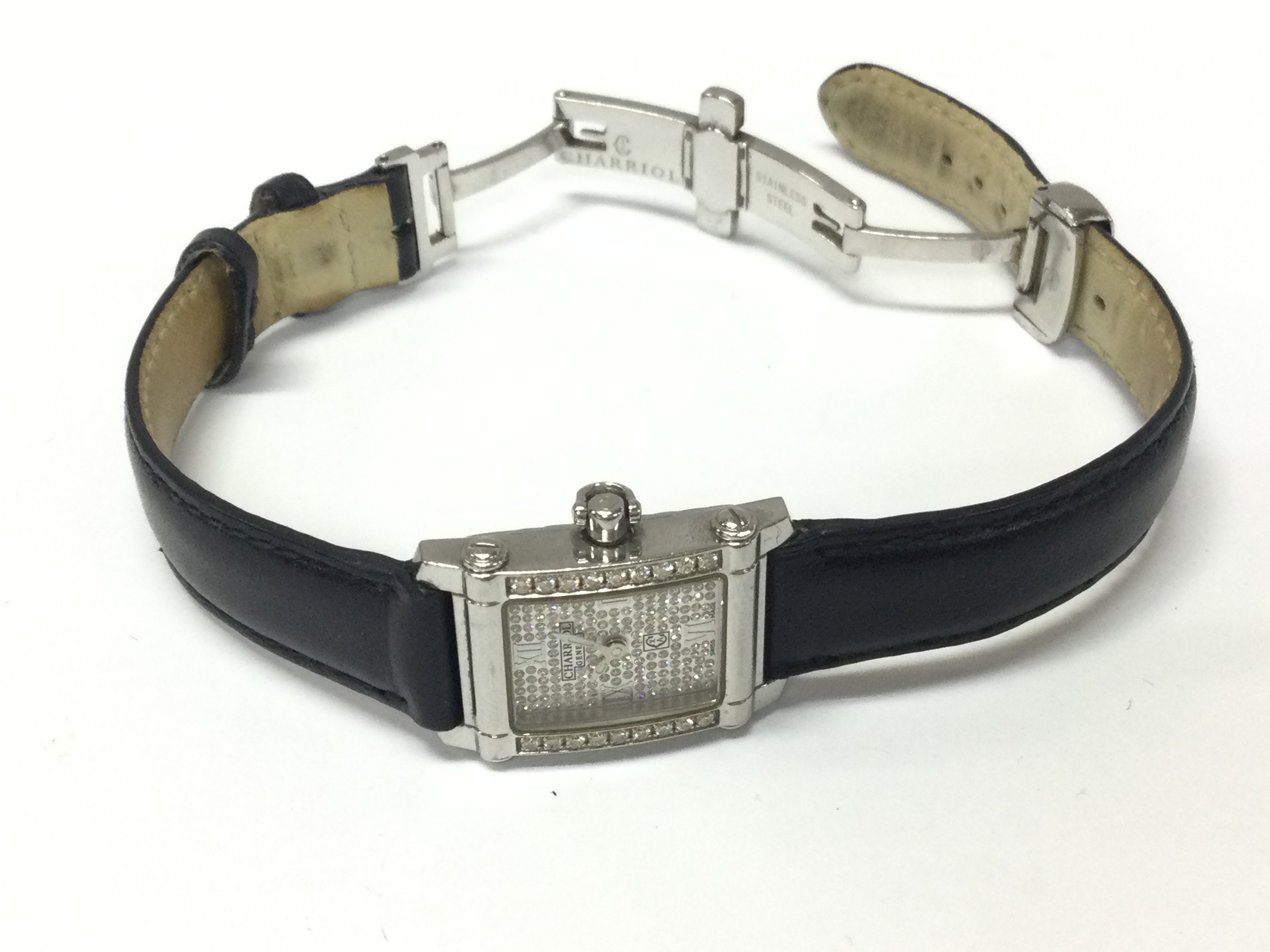 A Charriol diamond ladies watch on black leather strap.