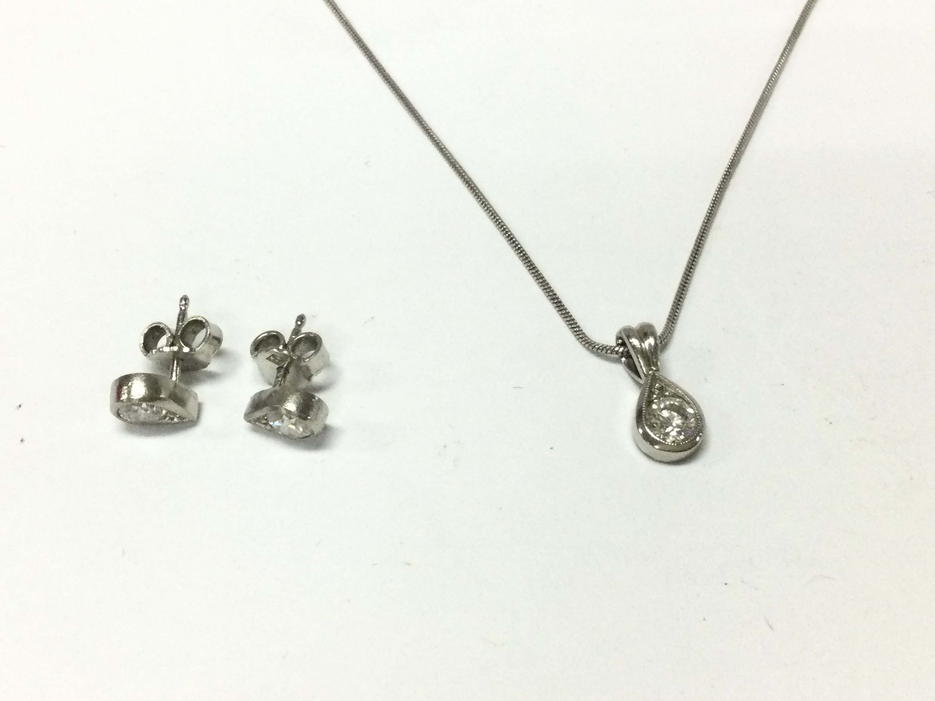 A platinum pendant set with diamond approx 0.and a pair of diamond earrings approx 0.71ct total.