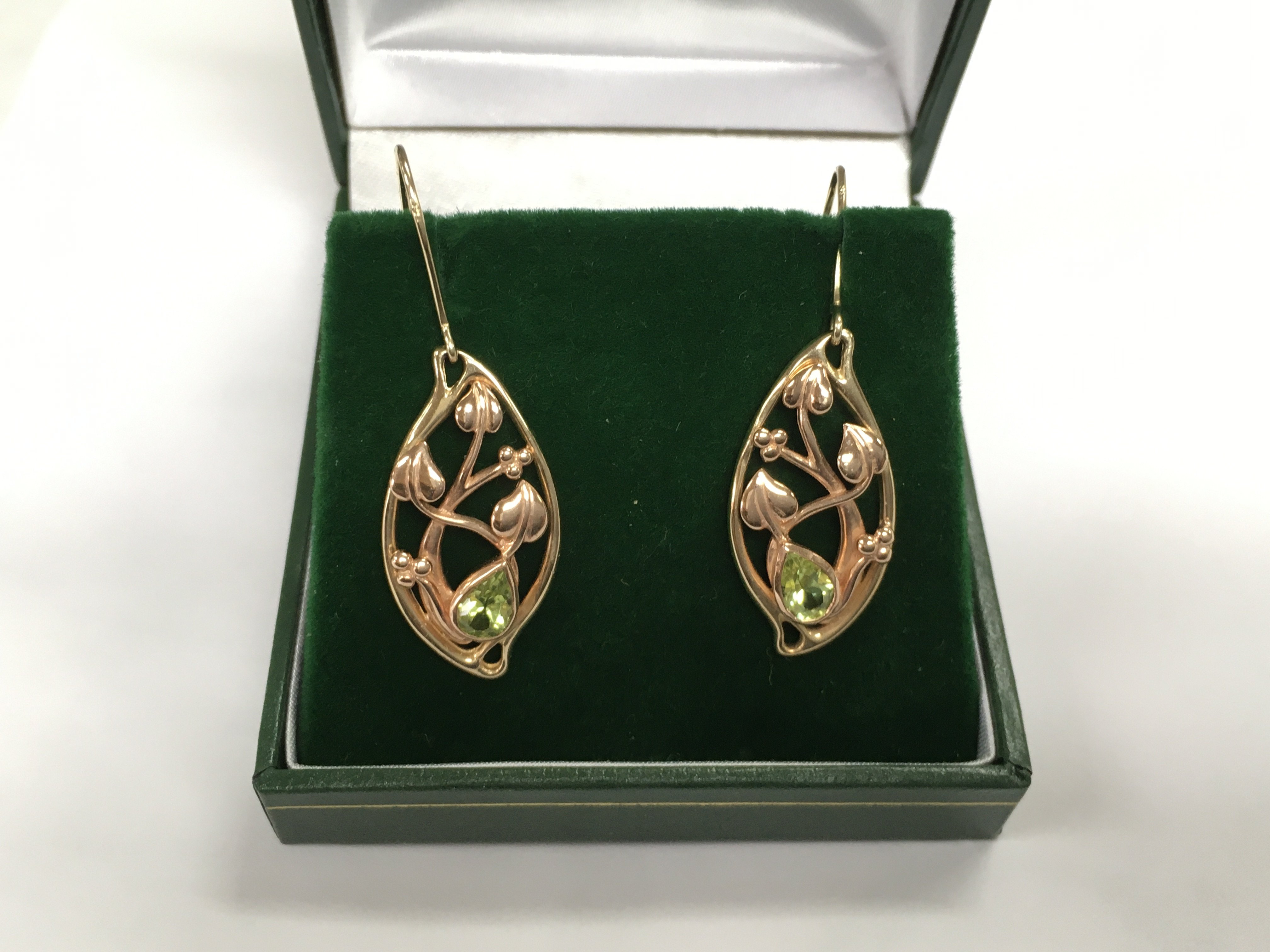 A pair of 10k Welsh bi coloured gold earrings set with peridot, approx 5g. Shipping category A.