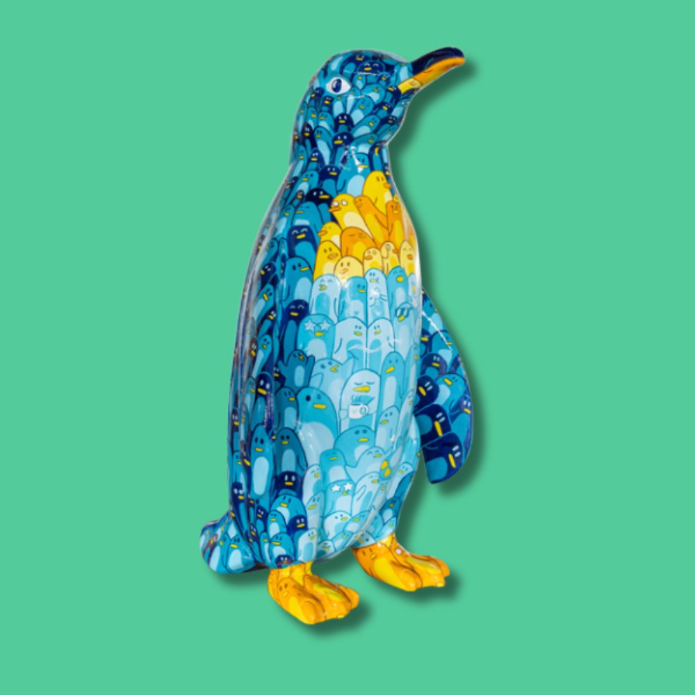 Waddle (SMALL SCULPTURE) - Sponsor: Main Media Video / Artist: Charlotte Adderley / This design is inspired by the name of the trail, Waddle, meaning a group of penguins. All these little penguins make up a larger penguin when stood from afar! Charlotte Adderley is an illustrator who enjoys creating characters and making art using diverse materials and techniques such as woodcarving, embroidery, and painting. Fascinated by nature, she especially loves drawing animals. Charlotte experiments with texture and aims to make her work pop with colour, bringing a playful vibrancy to her illustrations Height - 1000mm width 600mm depth 720mm weight 18kg