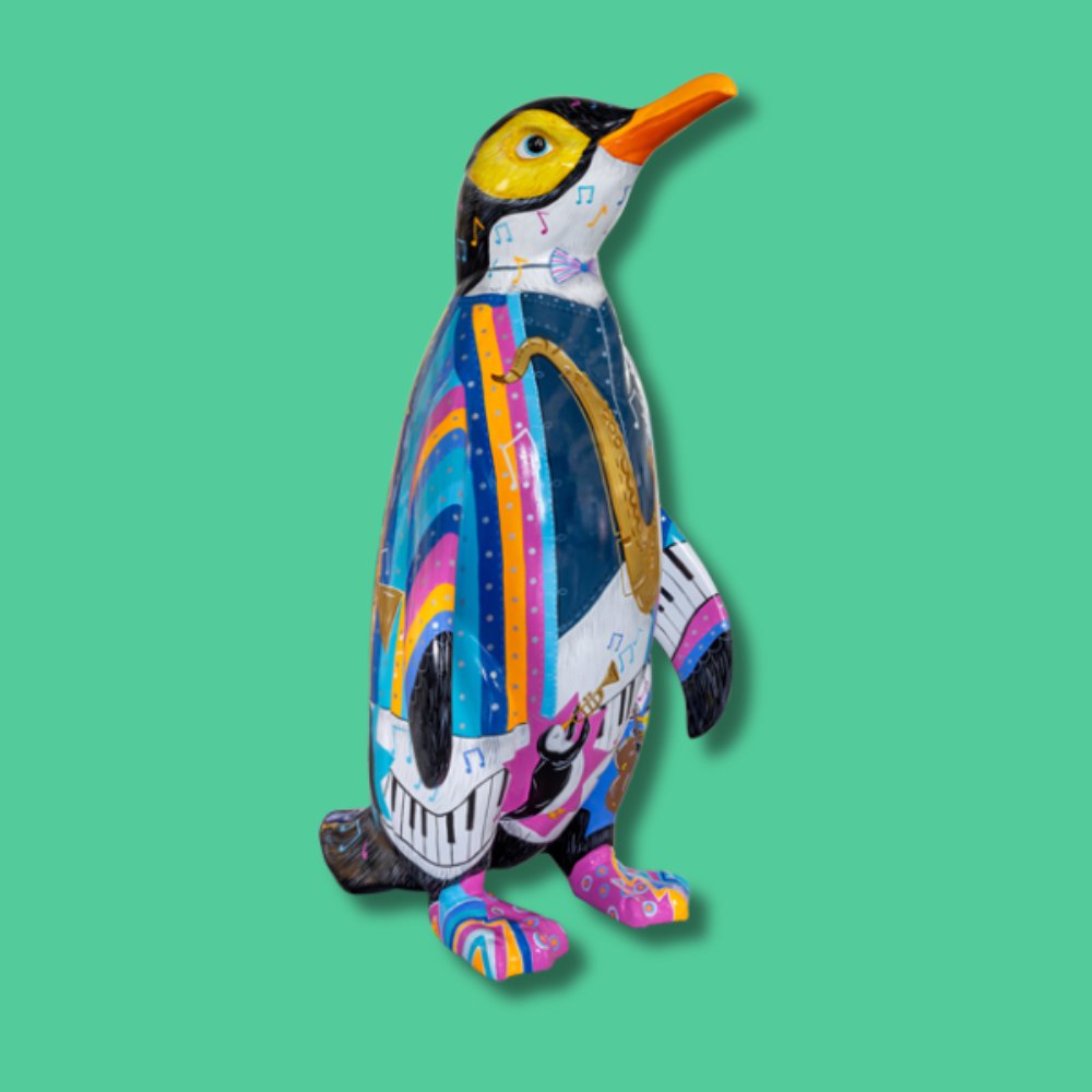 Jazzy Feet - Sponsor: Rickard Luckin / Artist: Phillippa & Rachael Corcutt / This vibrant penguin, dressed in a striped jacket and playing a saxophone, celebrates Southend-on-Sea's lively music scene, from the Southend Jazz Festival to the Jazz Centre UK. The design highlights jazz, community, and heritage, featuring penguins playing various instruments. Which one is your favourite? Rachael and Phillippa are twin sisters and illustrators working as a creative collective. Graduates of the University of Derby with First Class Honours in Illustration, they have illustrated for children's books, magazines, and greetings cards. Clients include Scholastic, Oxford University Press, and HarperCollins. They have painted over 40 sculptures for public art trails across the UK, bringing their playful, vibrant style to streets nationwide. - Height 1600mm width 890mm Depth 1090mm weight 30kg