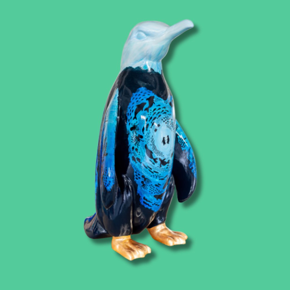 Love Beyond the Light (SMALL SCULPTURE) - Sponsor: Echo Newspaper / Artist: Carys June Hylands / This vibrant design features two central penguins surrounded by underwater creatures like whales, octopuses, sharks, sea turtles, manta rays, eels, and jellyfish. Bright colours swirl in the centre, darkening towards the bottom to suggest depth, while fading to white at the top. Carys is a self-established artist who studied art at university. She used her talents in art therapy during seven years working at a dementia care home in Leigh-on-Sea. Carys curated Admiral Court's Remi the Reminiscent Elephant for the Herd In The City art trail. She later became closely connected with Fair Havens after her partner was diagnosed with terminal cancer just months later. Height - 1000mm width 600mm depth 720mm weight 18kg