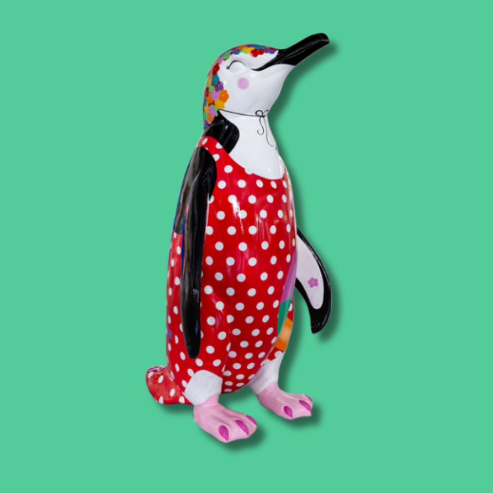 Peggy Makes a Splash! - Sponsor: The Royals Shopping Centre / Artist: Marnie Maurri / Say hello to Peggy! Peggy is a world-class synchronised swimmer, and while all the other penguins are out catching fish, she is practising her routines. Peggy's favourite things are iced gems, glamorous swimwear, and her very fancy floral bathing cap collection! Marnie is an independent artist and illustrator with a background in theatre design. Based in Worcestershire, she creates from her home studio, crafting whimsical scenes filled with charming characters and intricate details. Heavily inspired by nature, her colourful, playful, and joyful work invites viewers into imaginative, magical worlds that celebrate the beauty of the natural environment. - Height 1600mm width 890mm Depth 1090mm weight 30kg