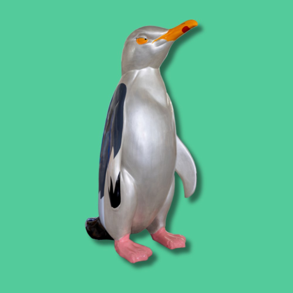 Chip - Sponsor: Revive Digital / Artist: James Higgs / James designed his penguin as a character that embodies the spirit of Southend-on-Sea, creating something that both children and adults can connect with. His aim was to craft a friendly, memorable figure that brings a sense of fun and nostalgia, inviting people of all ages to interact with him and capture special moments. His playful design is a joyful and relatable mascot for residents and visitors alike. James Higgs is a Southend-on-Sea-based multidisciplinary artist whose work reflects eco-activism, conservation, and punk culture. He combines bold illustration and design to challenge viewers and highlight the environmental impact of human behaviour. James also leads creative projects at Rev.01 Studio in Southend, delivering branding, video, and digital content. - Height 1600mm width 890mm Depth 1090mm weight 30kg