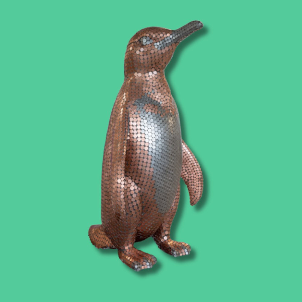 Sir Waddle-a-lot - Sponsor: MWS / Artist: Angus / Sir Waddle-a-lot is made entirely out of UK circulated coins including 1p pieces, 2p pieces, 5p pieces and 10p pieces to cover every inch of his body, from beak to tail. The hard-wearing durability of using smooth metal coins means it will last a lifetime. He will shine day or night, in any light. Angus is an independent 8-Bit artist who specialises in tiles, coins, and Lego. Since 2015, he has self-taught his practice without formal art training. His distinctive, tongue-in-cheek style draws inspiration from retro arcade games and people in his life. Angus creates unique work for sculpture trails, galleries, and street exhibitions, bringing nostalgic flair and creativity to the public art scene. - Height 1600mm width 890mm Depth 1090mm weight 30kg