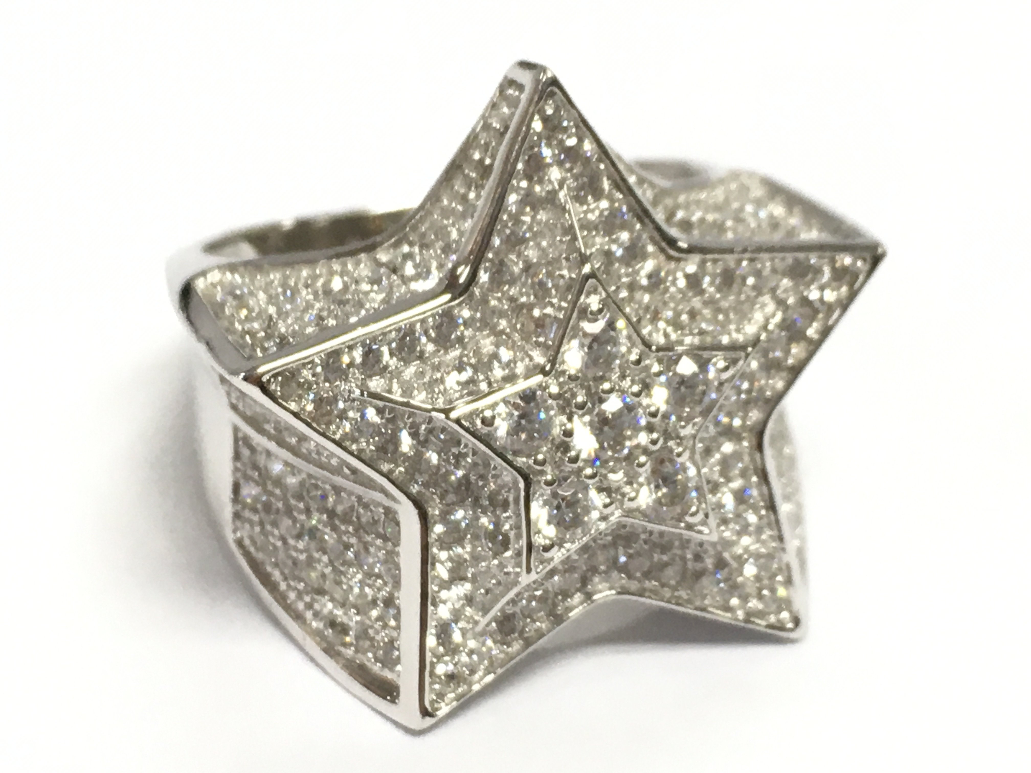 A large silver cubic zirconia dress ring in a star shape , size S. 