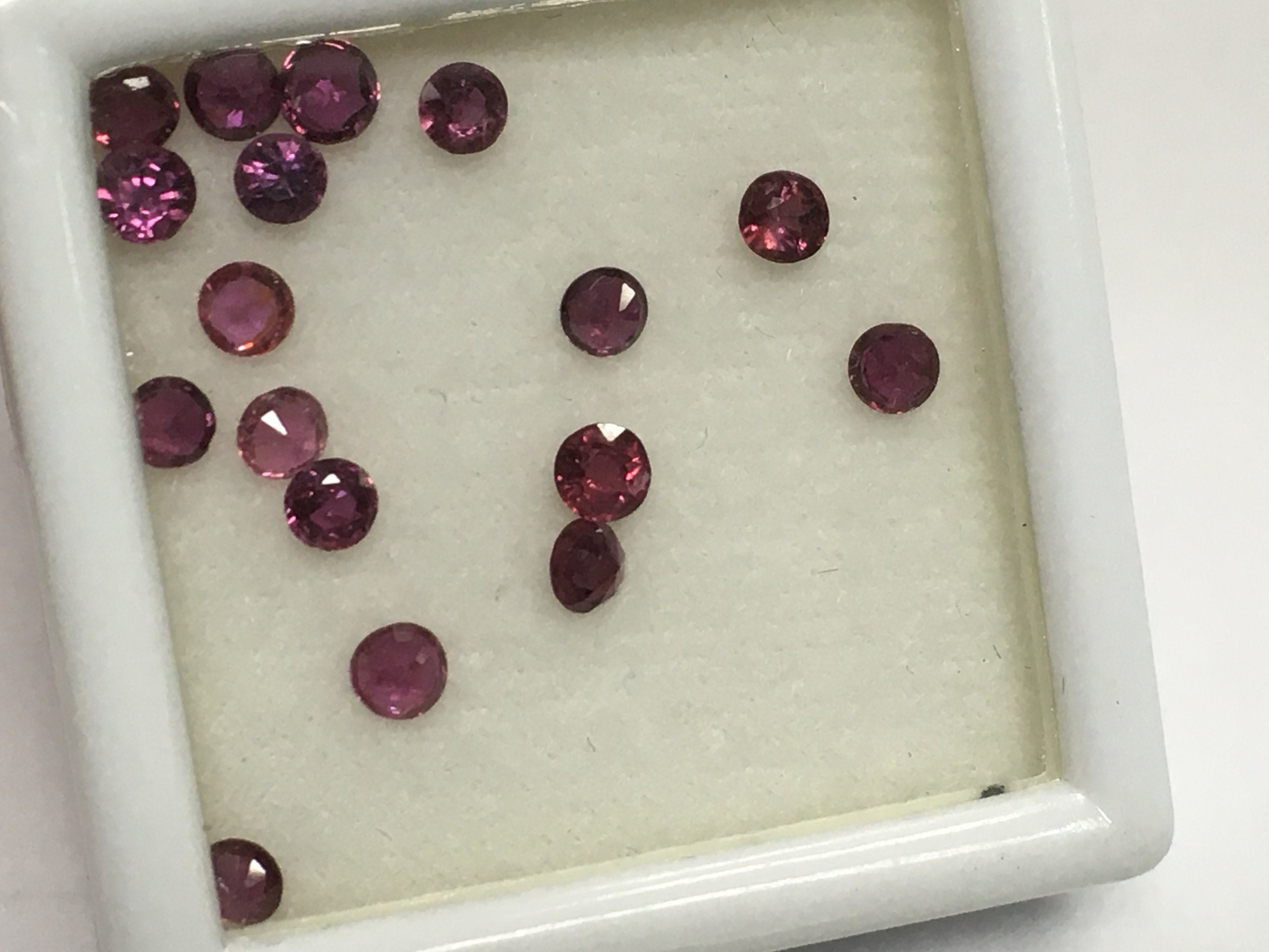 A parcel of 17 round cut rubies , totalling 3.25ct boxed