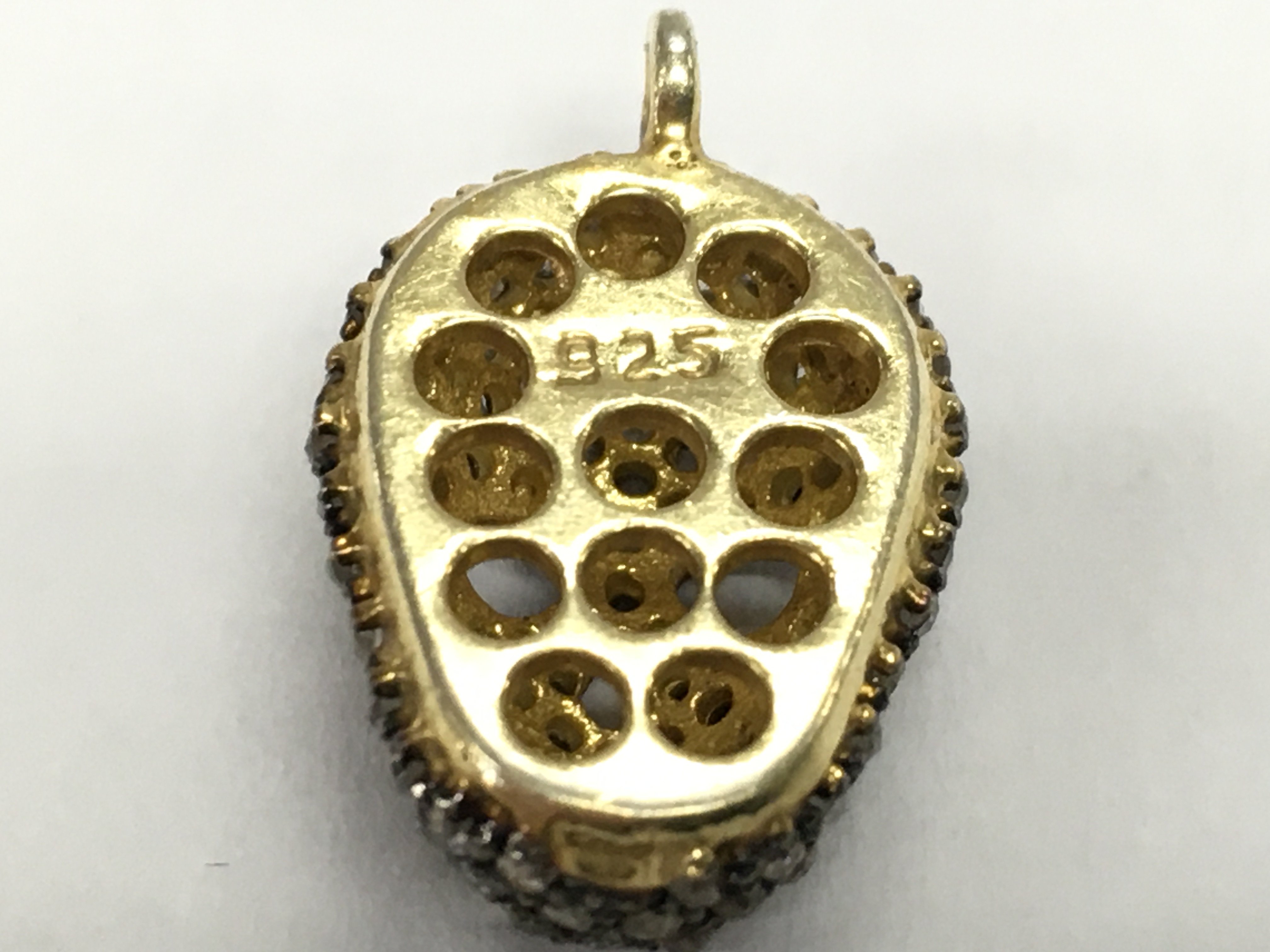A gold plated silver diamond encrusted skull pendant , diamond 0.65ct approx