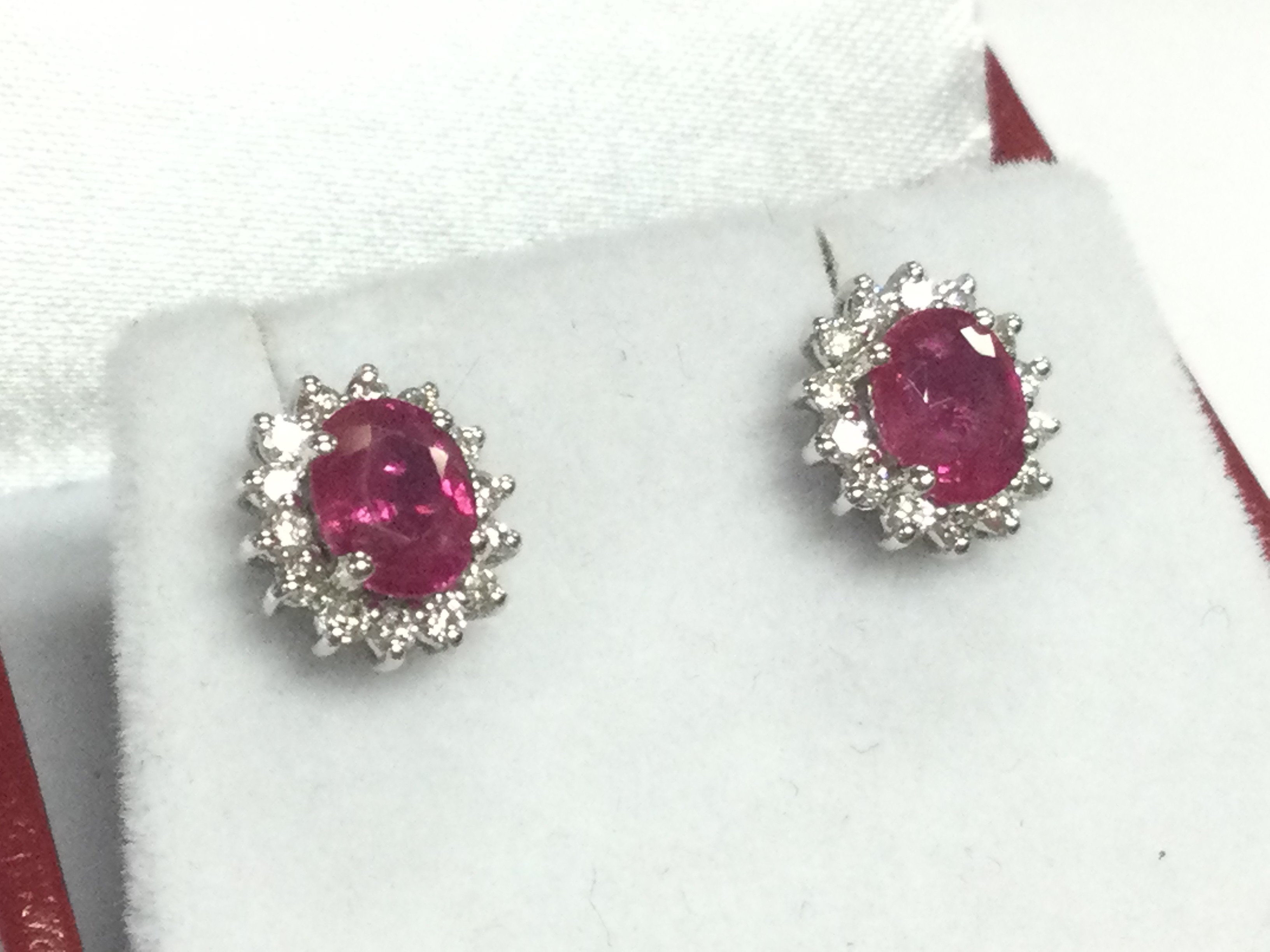 Pair of 18ct white gold oval ruby and RBC diamond cluster studs, boxed. Rubies 1.00ct approx. Diamonds 0.30ct approx . 2.8g total weight 