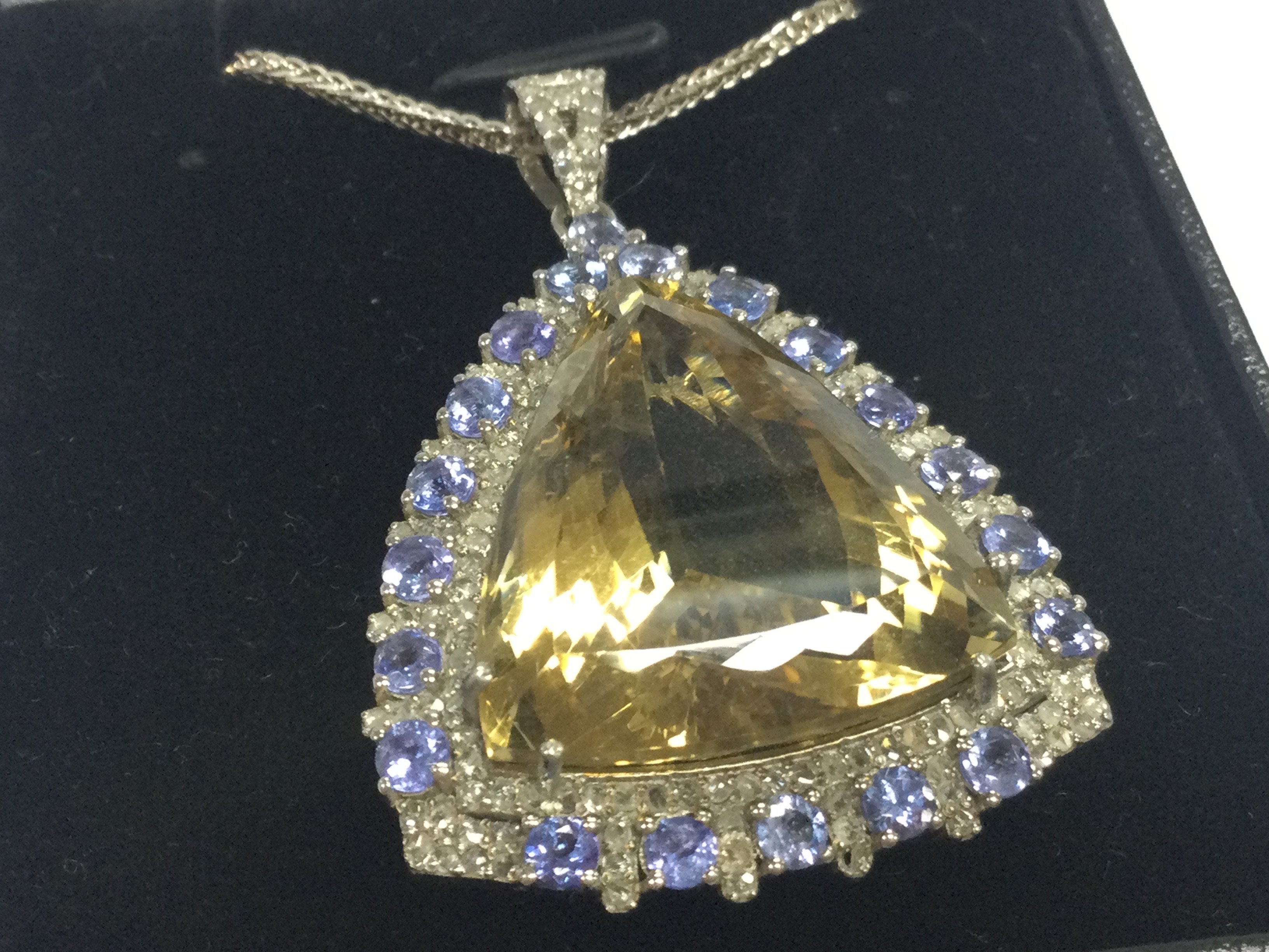 Large silver pendant set with triangle cut citrine , tanzanites and diamonds on a silver chain, boxed. Citrine 20.00ct approx. Tanzanites 2.00ct approx . Diamonds 0.75ct
