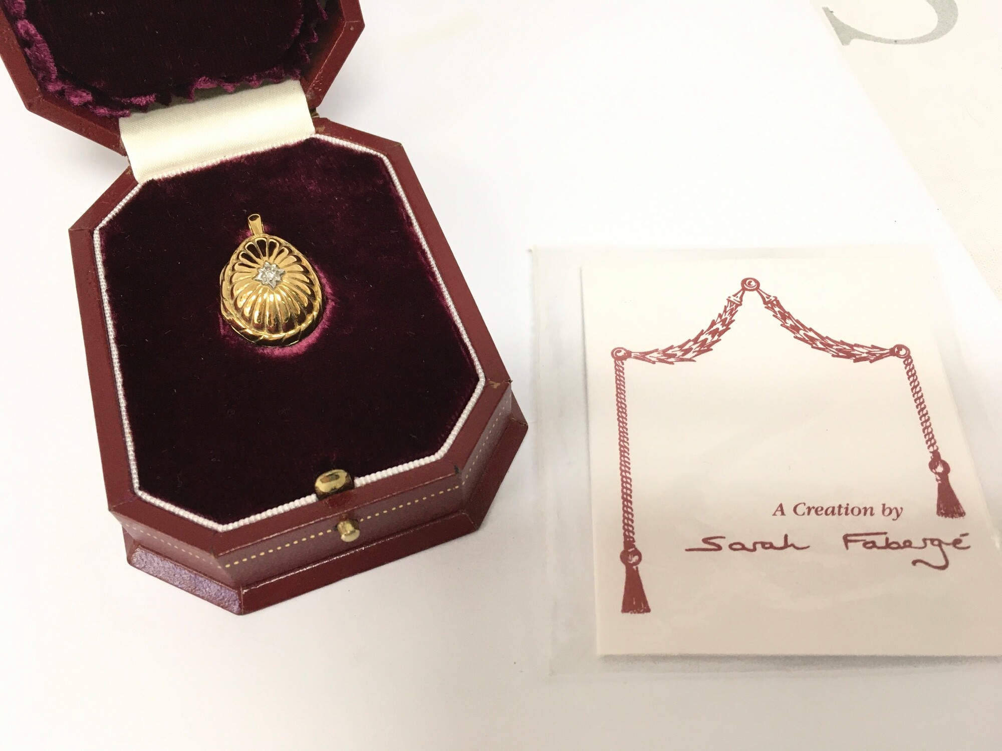 A boxed Limited Edition silver gilt Sarah Fabergé egg pendant, diamond set and with cultured Pearl. Postage category A